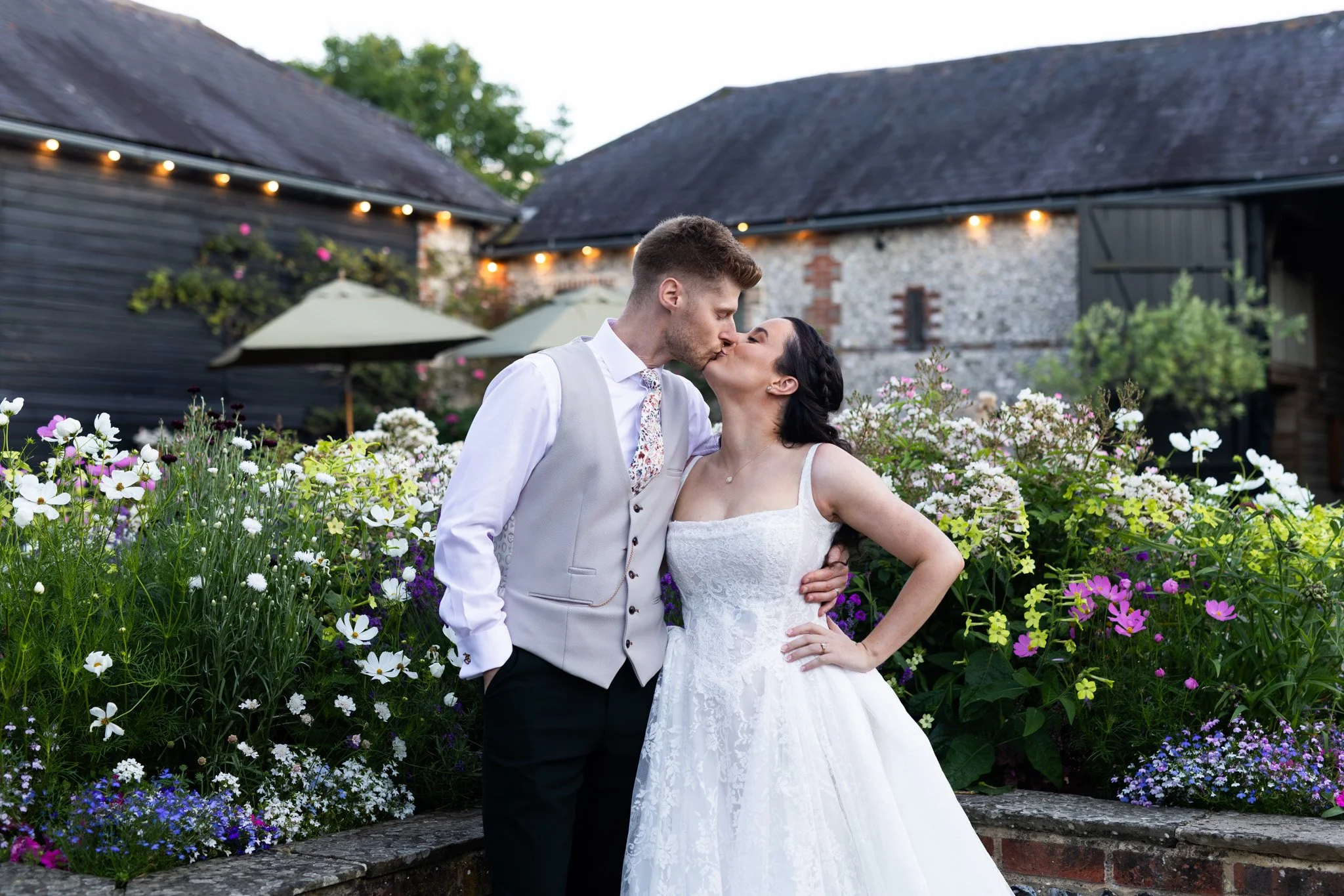 The bride and groom share a kiss at blue hour in the central courtyard