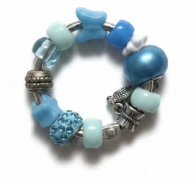A circular charm bracelet with various blue and silver beads and charms.