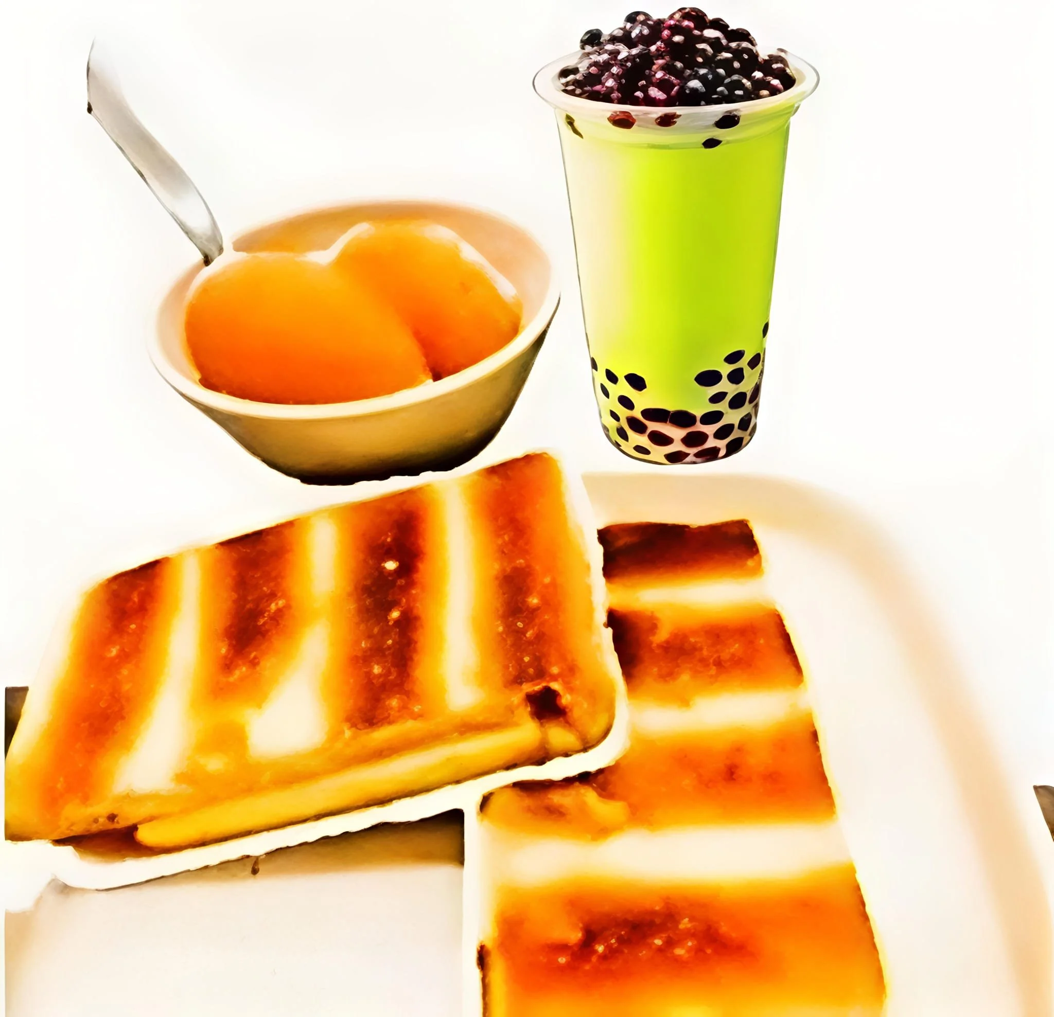 Close-up of a bowl of 2 eggs and a cup of green tea with black konjac jelly.