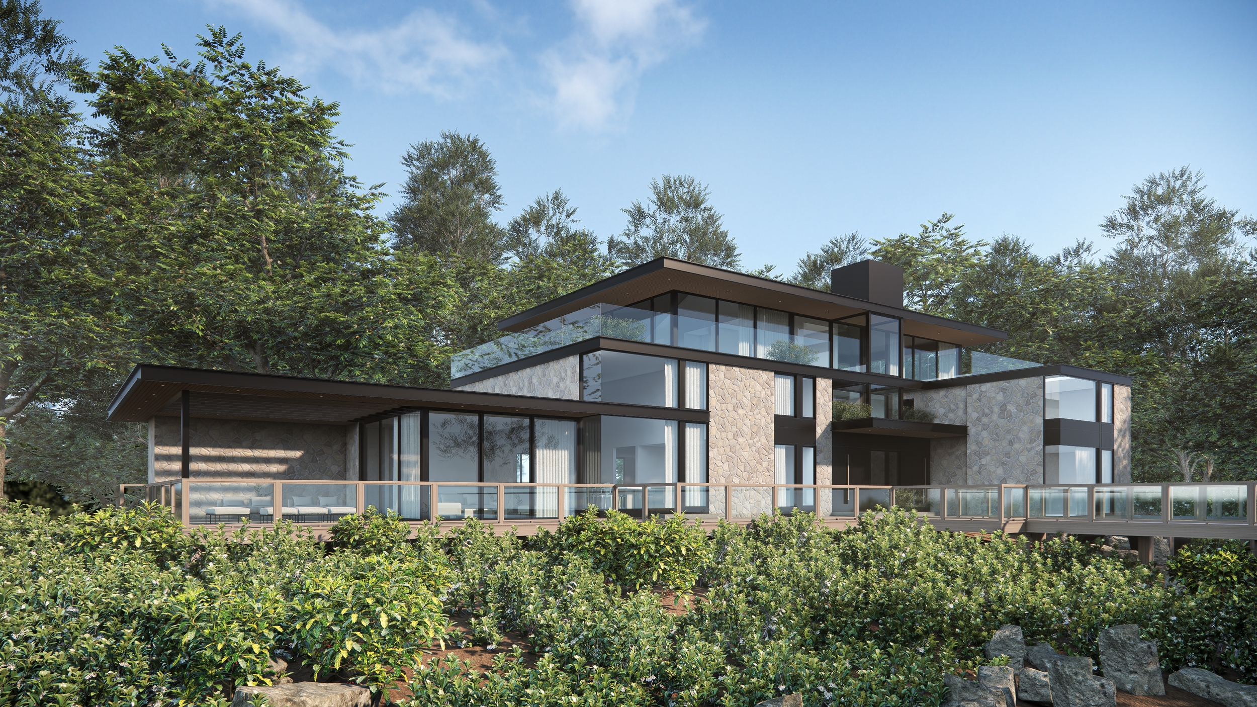 Modern multi-story house with large glass windows, stone walls, and surrounded by lush green trees and shrubbery.