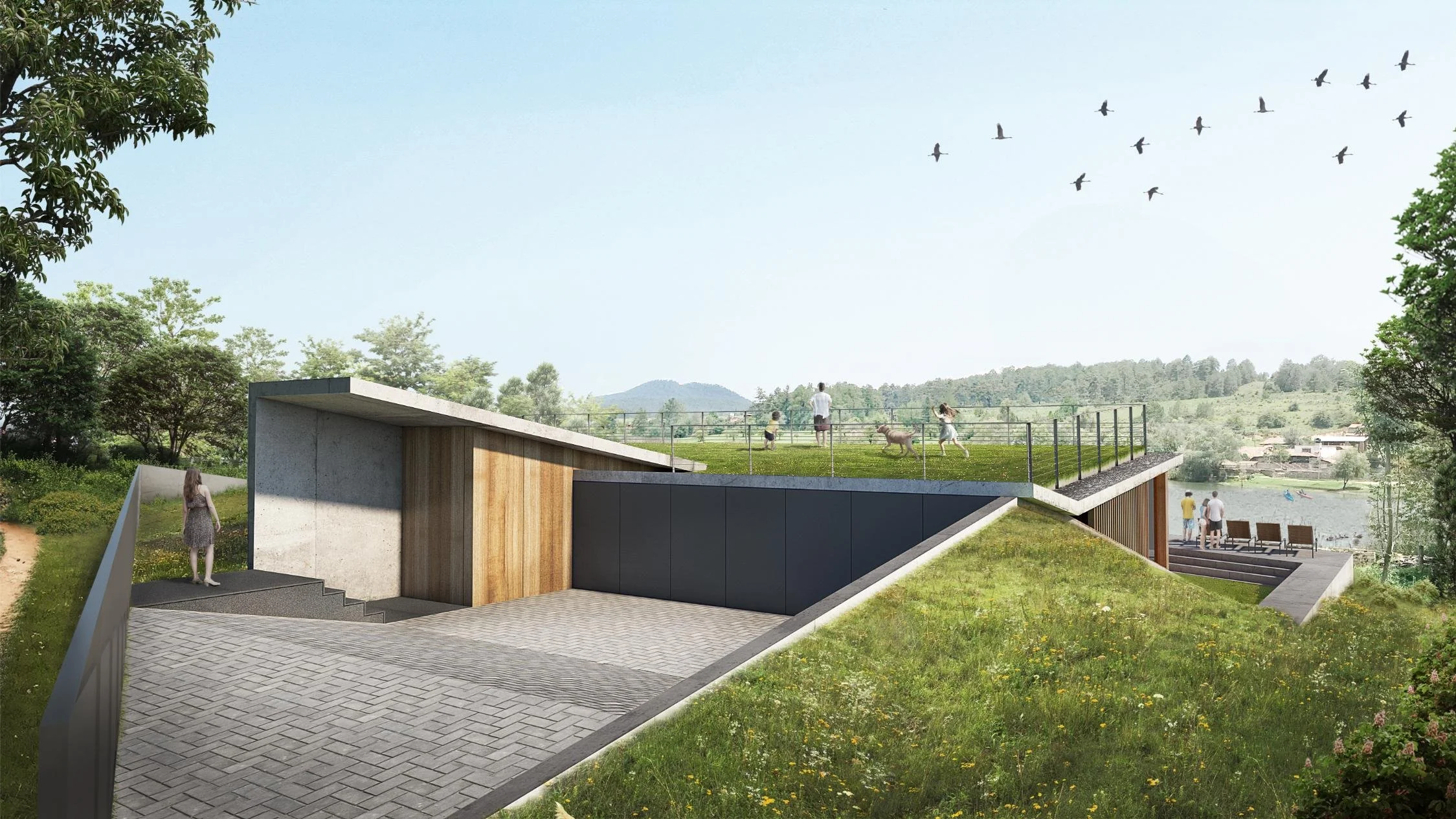 Entrance and green roof deck of a modern home integrated into a grassy hillside overlooking a lake