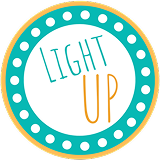Circular badge with dotted border, containing the words "LIGHT UP" in teal and orange