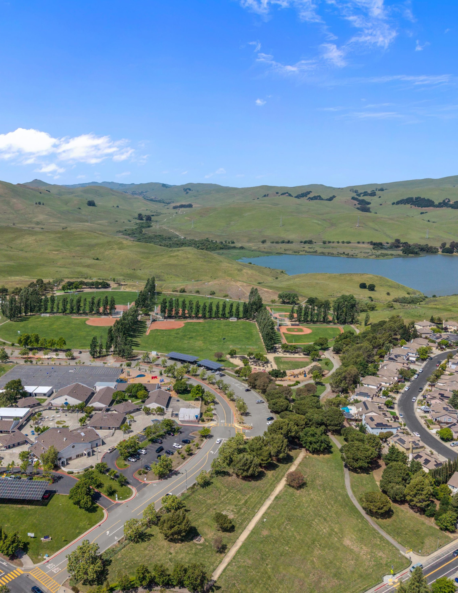 A landscape of mountains with a lake in the foreground, overcast sky