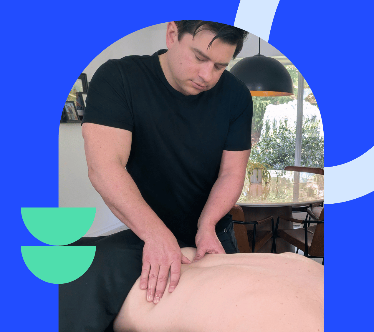 A clinical massage therapist performing targeted deep tissue back therapy in a client's home on the Eastside.