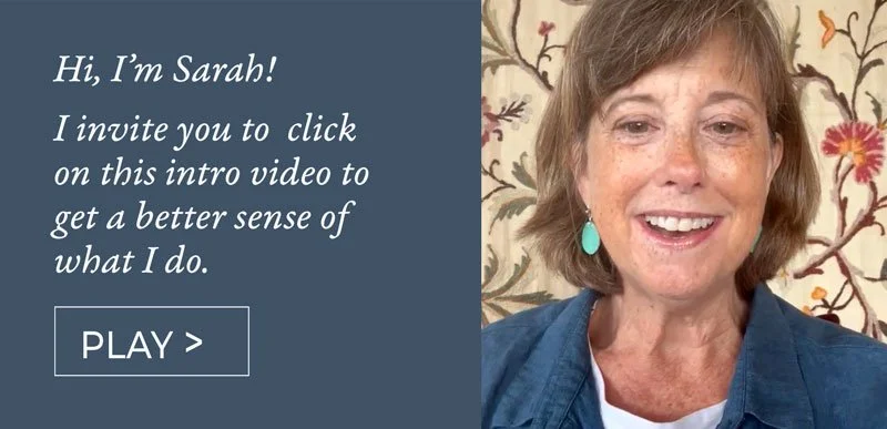 A woman named Sarah smiling in front of a floral wallpaper, with an invitation to click on a video to understand what she does.