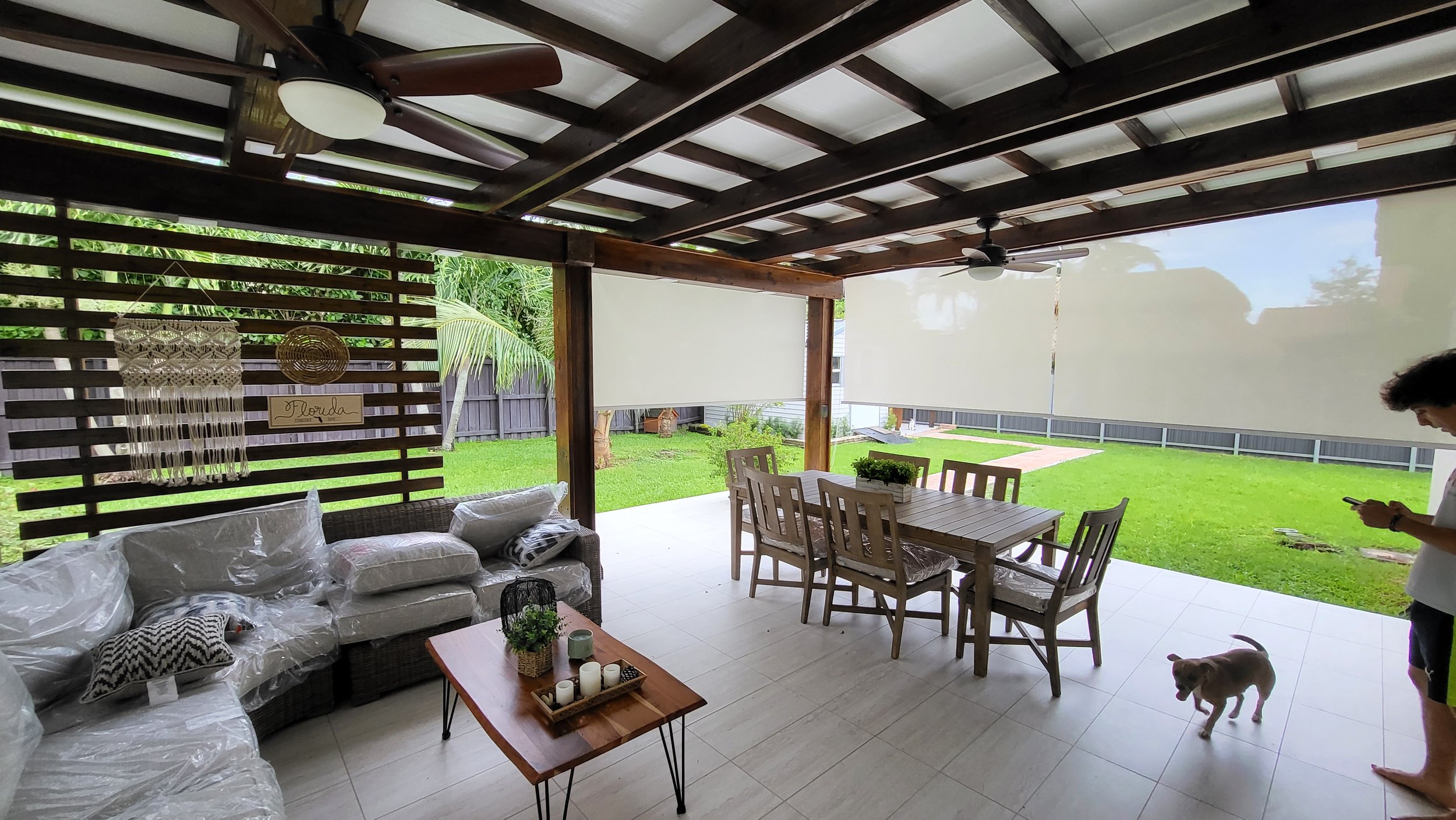 Covered patio with outdoor anchored exterior shades.