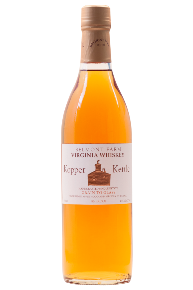 A bottle of Belmont Farm Virginia Whiskey Copper Kettle, handcrafted single estate, with a label indicating 86 proof and 43% alcohol, made from apple wood and Virginia white oak, with a copper-colored cap.