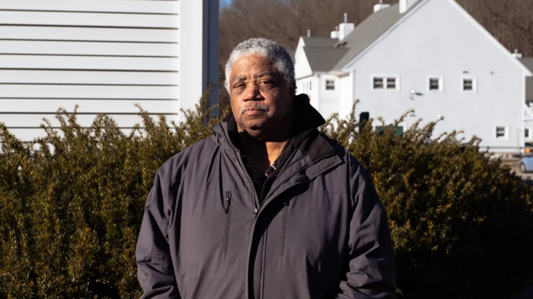 Alphonso Coles stands in front of Brookside Housing co-op, where he is both a resident and acts as treasurer. Co-ops are unique models that keep housing affordable and allow residents to buy shares in their housing development so they can take votes 