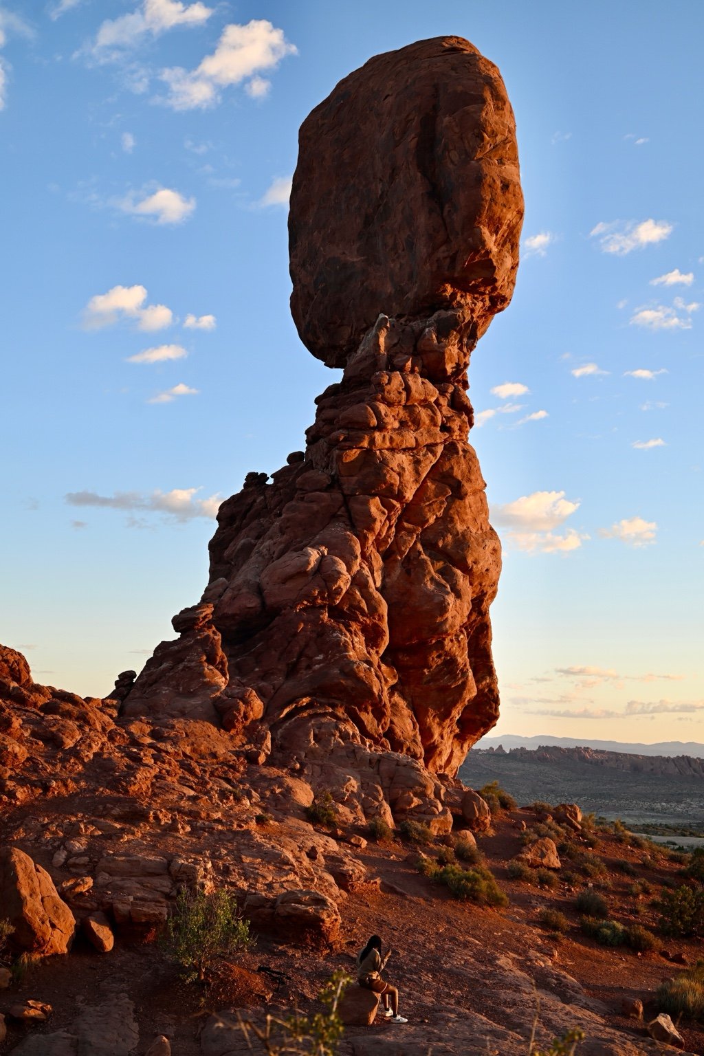 Balanced Rock formation at sunset in Arches National Park, representing balance, reflection, and wellness.