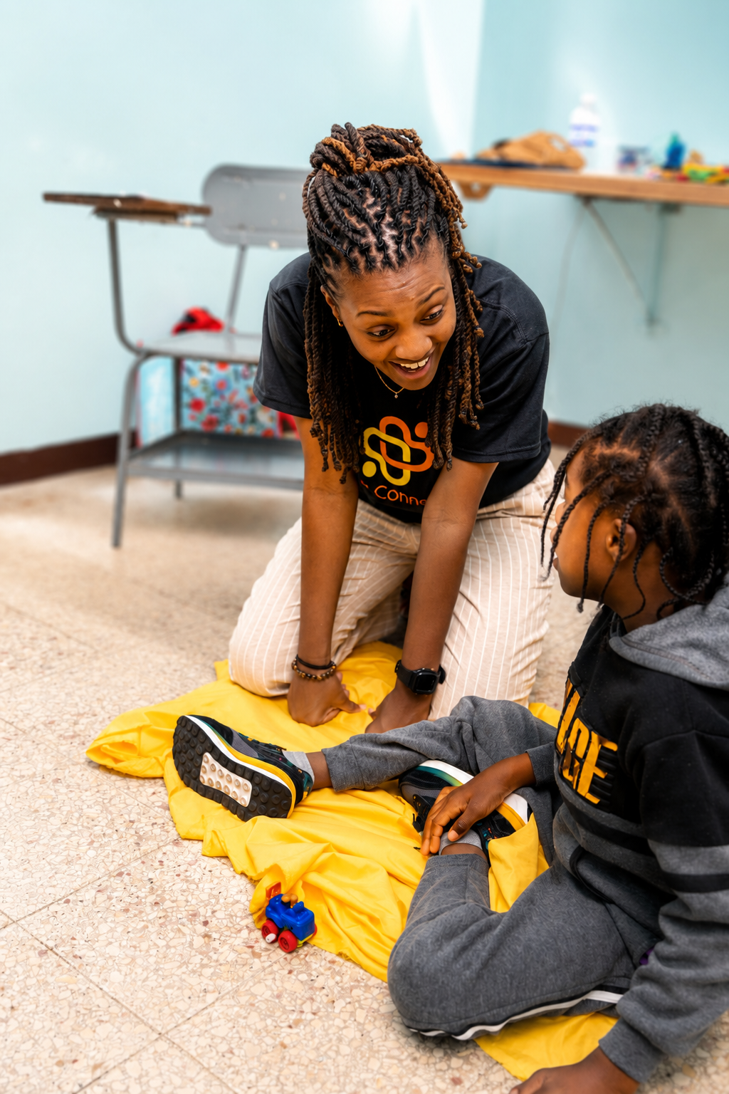 Dr. Shavonne engaging with a child during an occupational therapy session on a non-profit trip.