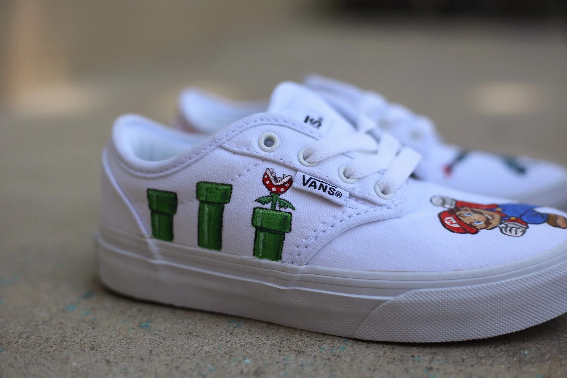 White Vans sneaker with hand-painted Mario characters. hand painted kids shoes with well known cartoon and video game characters. 