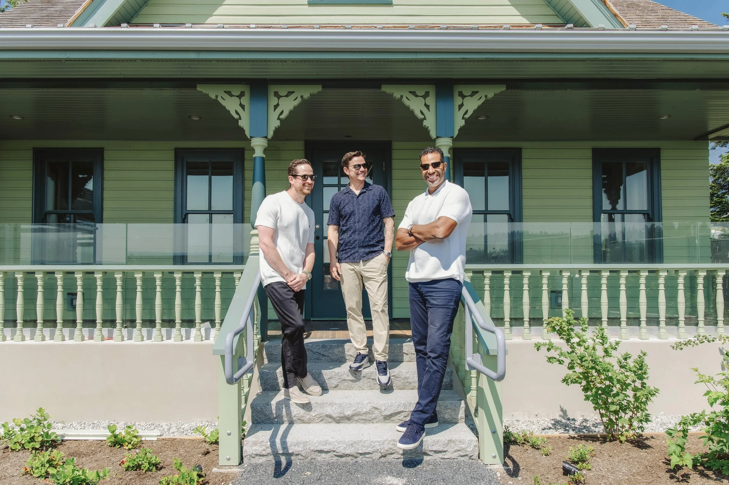 Operating Partners from left to right Mike Rose, Teddy Wilkie, Justin Mensah-Coker stand on the porch of newly restored Navvy House