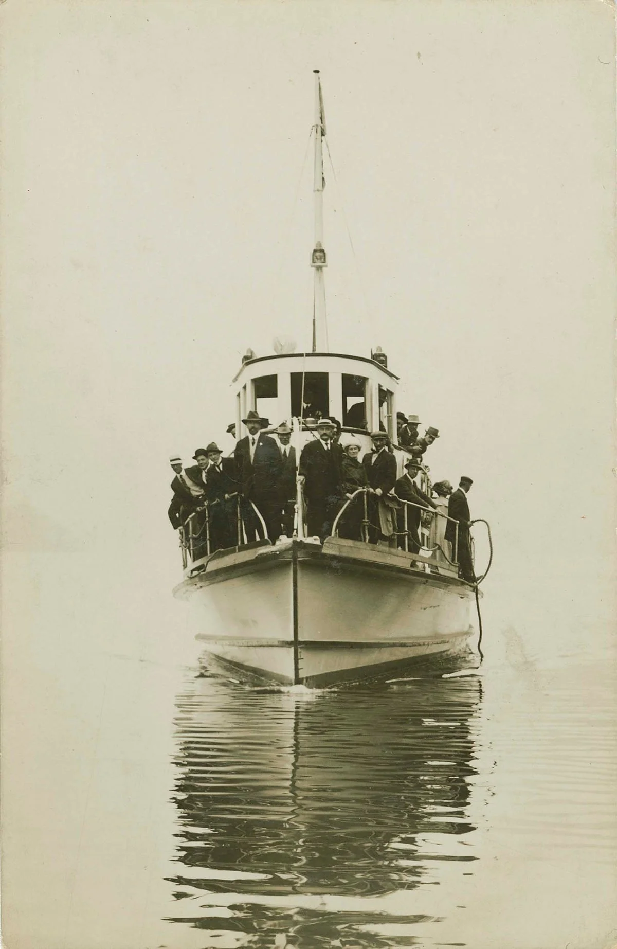 Item is a postcard of West Vancouver ferry Sonrisa on its inaugural trip to Horesehoe Bay. John Lawson is standing on the bow just right of centre and Christina (Smith) Lawson is standing to his left.