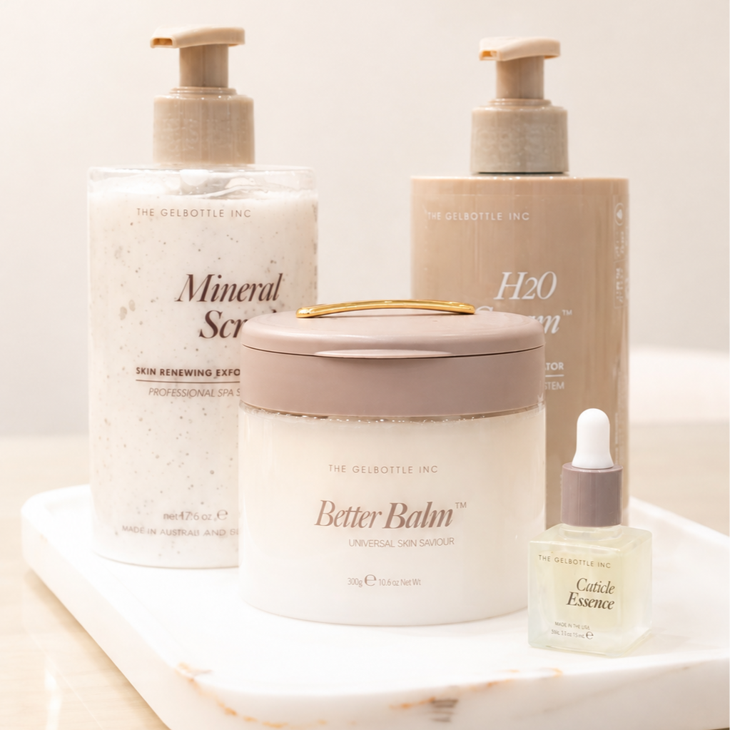 Skincare products on a white tray, including a mineral scrub, hydration gel, a jar labeled Better Balm, and a small dropper bottle of Cactice Essence.