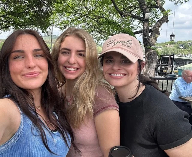 Photo of Andrea wearing a hat with 2 other girls
