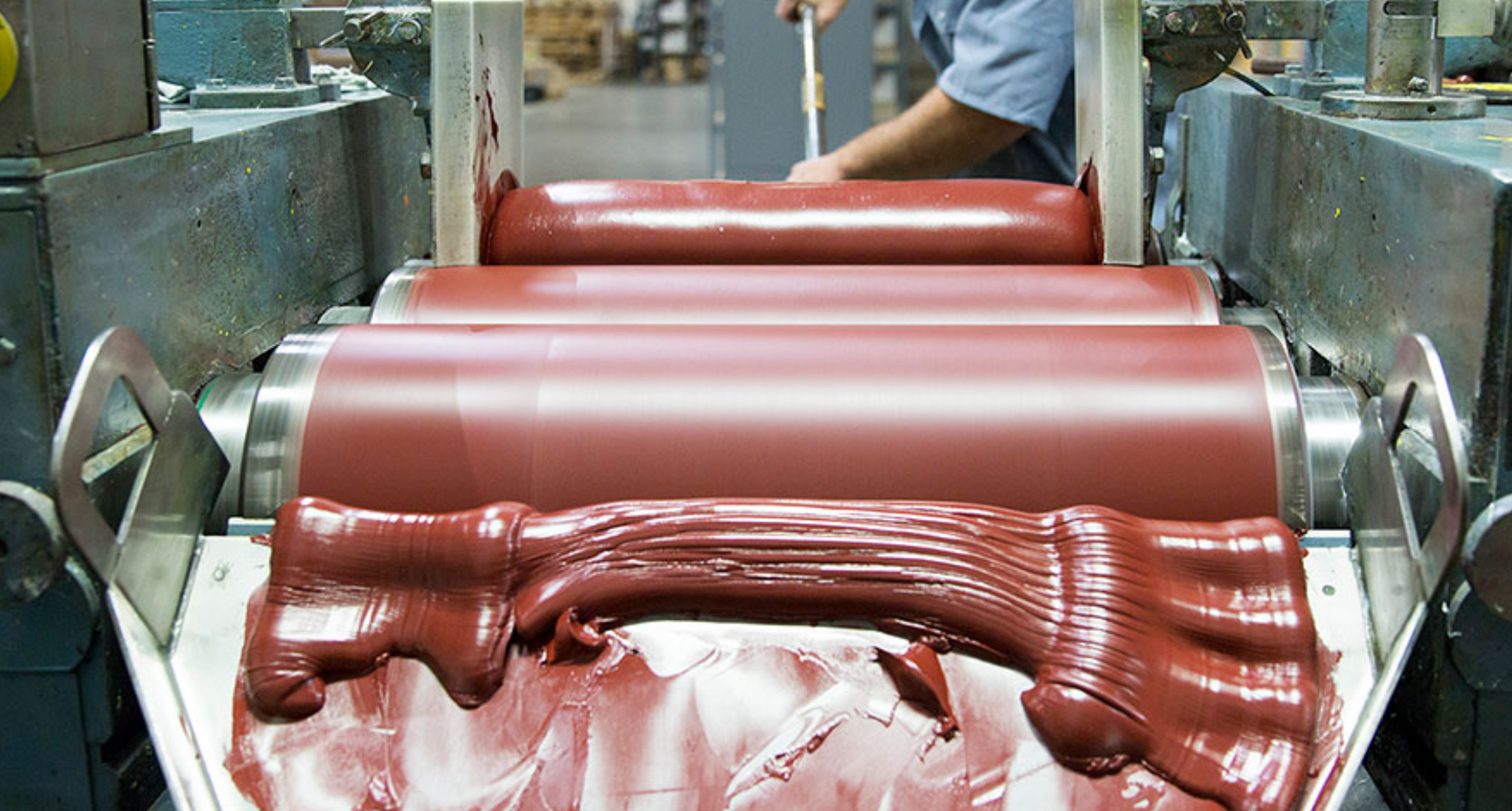 Gamblin making red oil paint on rollers.png