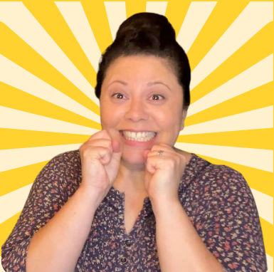 A woman with dark hair in a bun, smiling with excitement, in front of a yellow sunburst background.