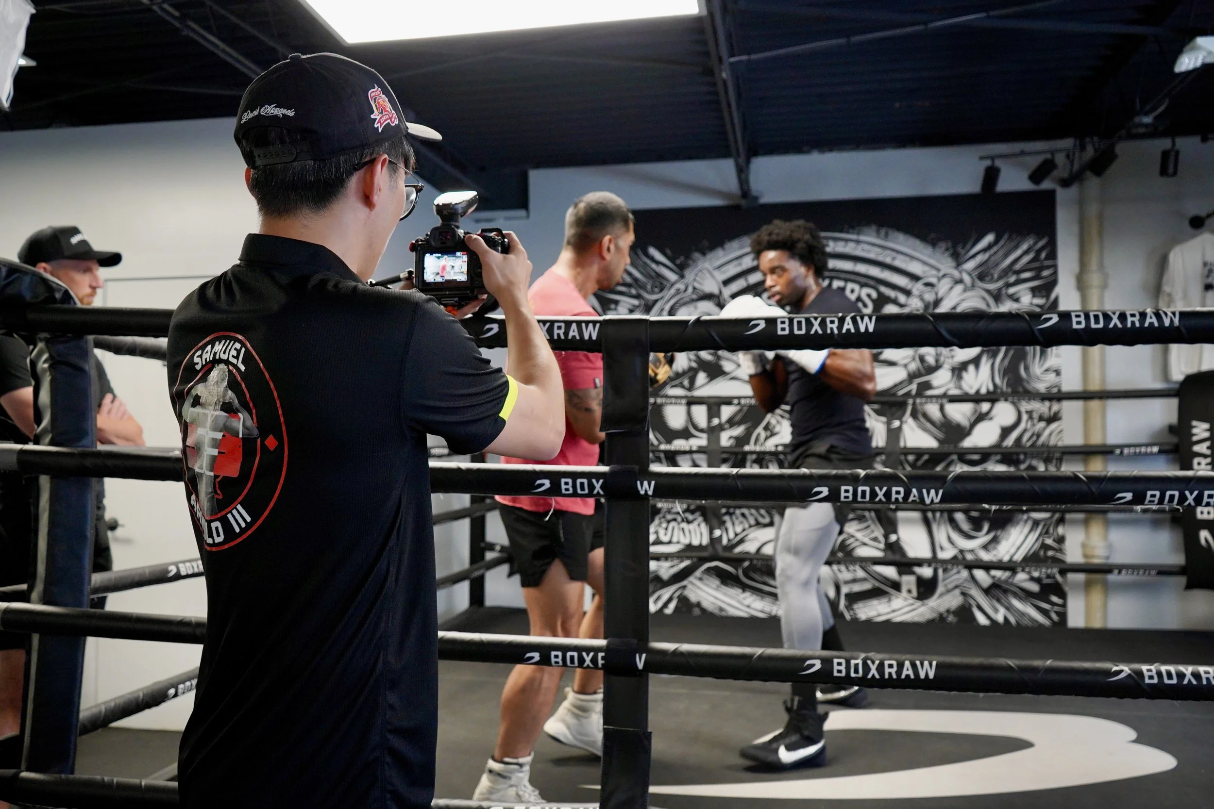 Samuel "S3" Arnold III works the mitts with trainer John Pruna inside the ring at a Strikers gym.