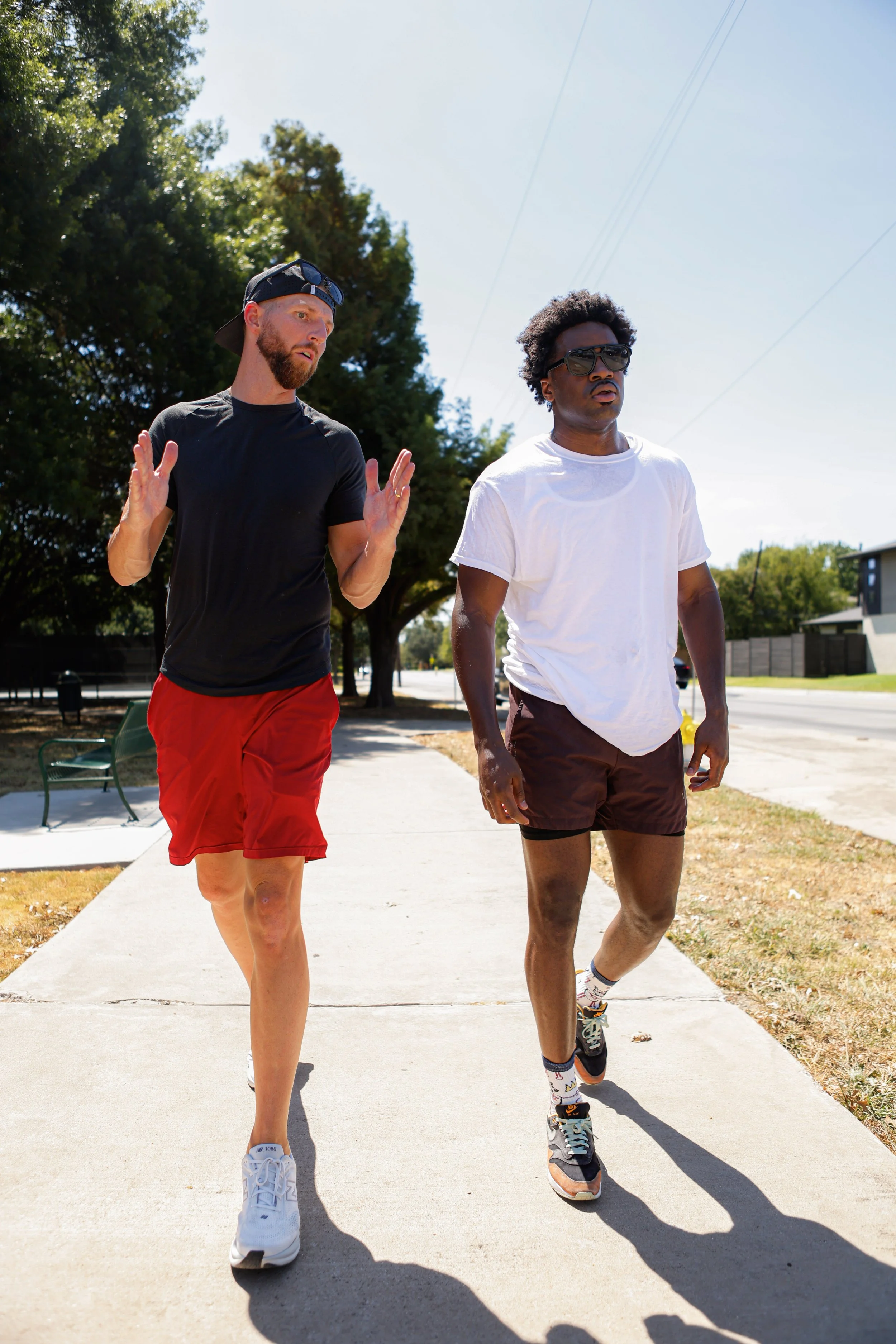 Samuel "S3" Arnold III and Coach Andrew Banner walking and talking outdoors during fight camp.