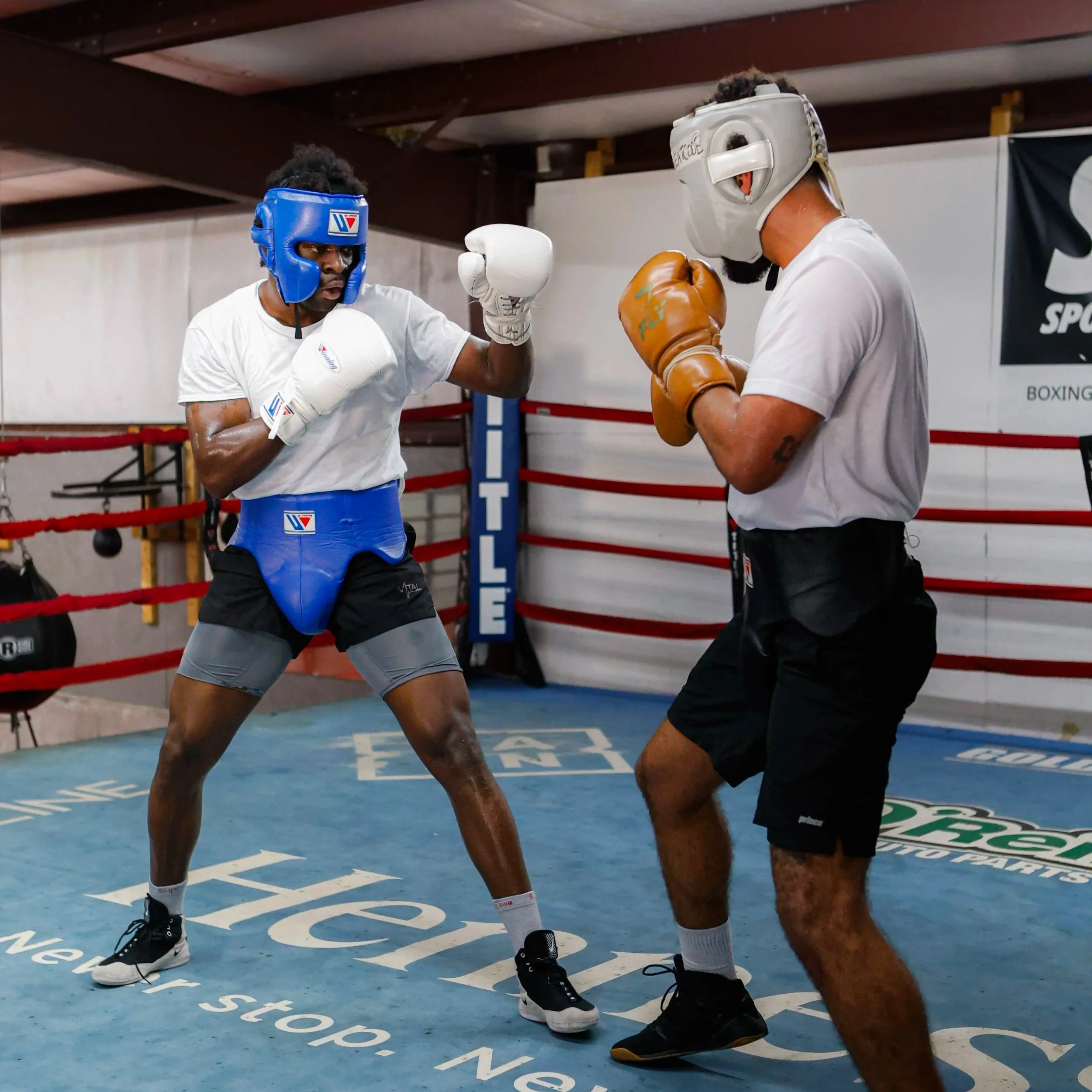 Samuel "S3" Arnold III sparring in headgear and gloves with a training partner during fight camp preparation.