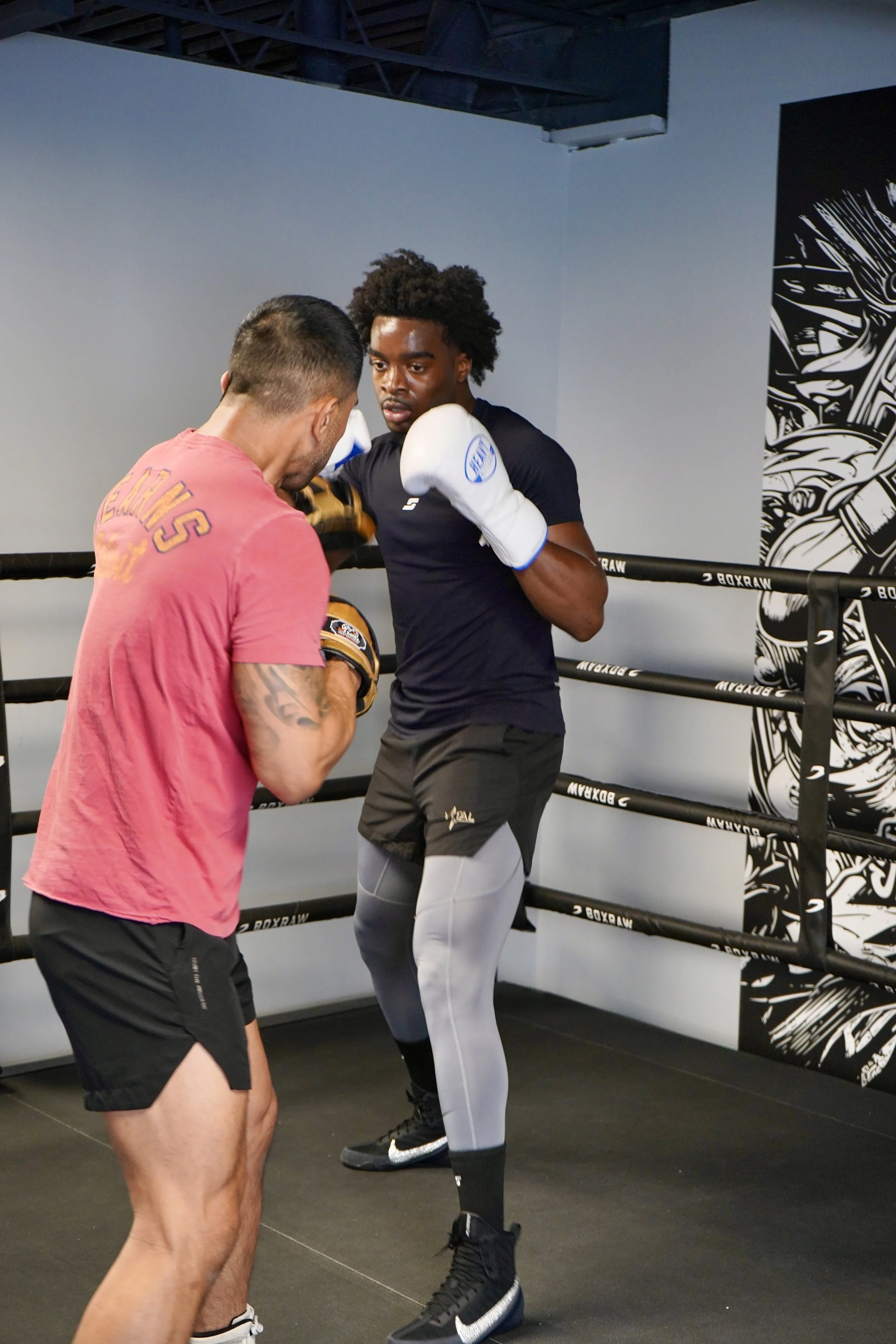 Samuel "S3" Arnold III works the mitts with trainer John Pruna at a Strikers gym in Dallas, Texas.