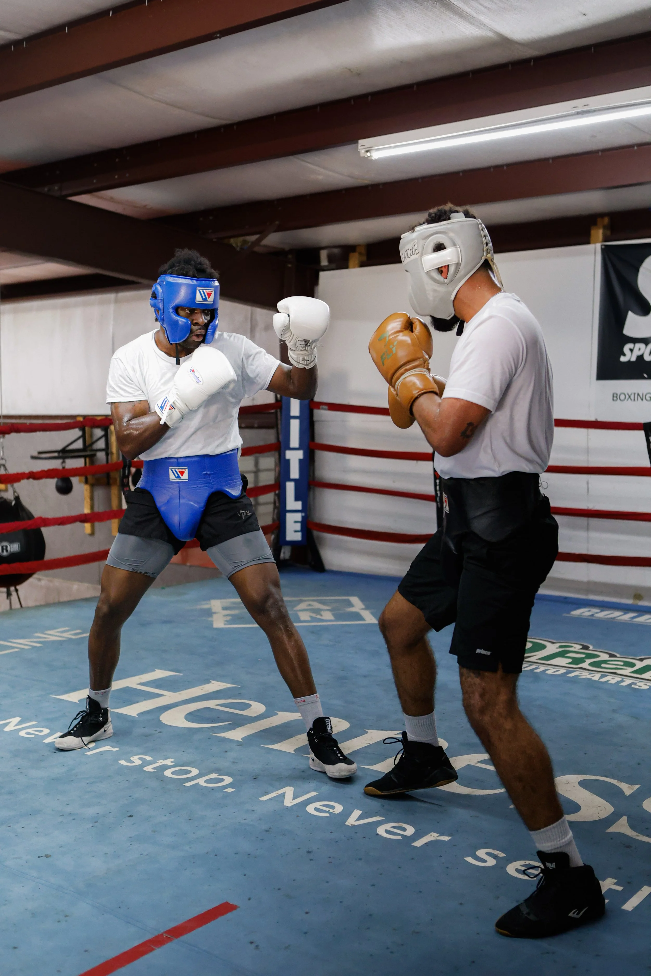 Samuel "S3" Arnold III sparring in headgear and gloves with a training partner during fight camp preparation.