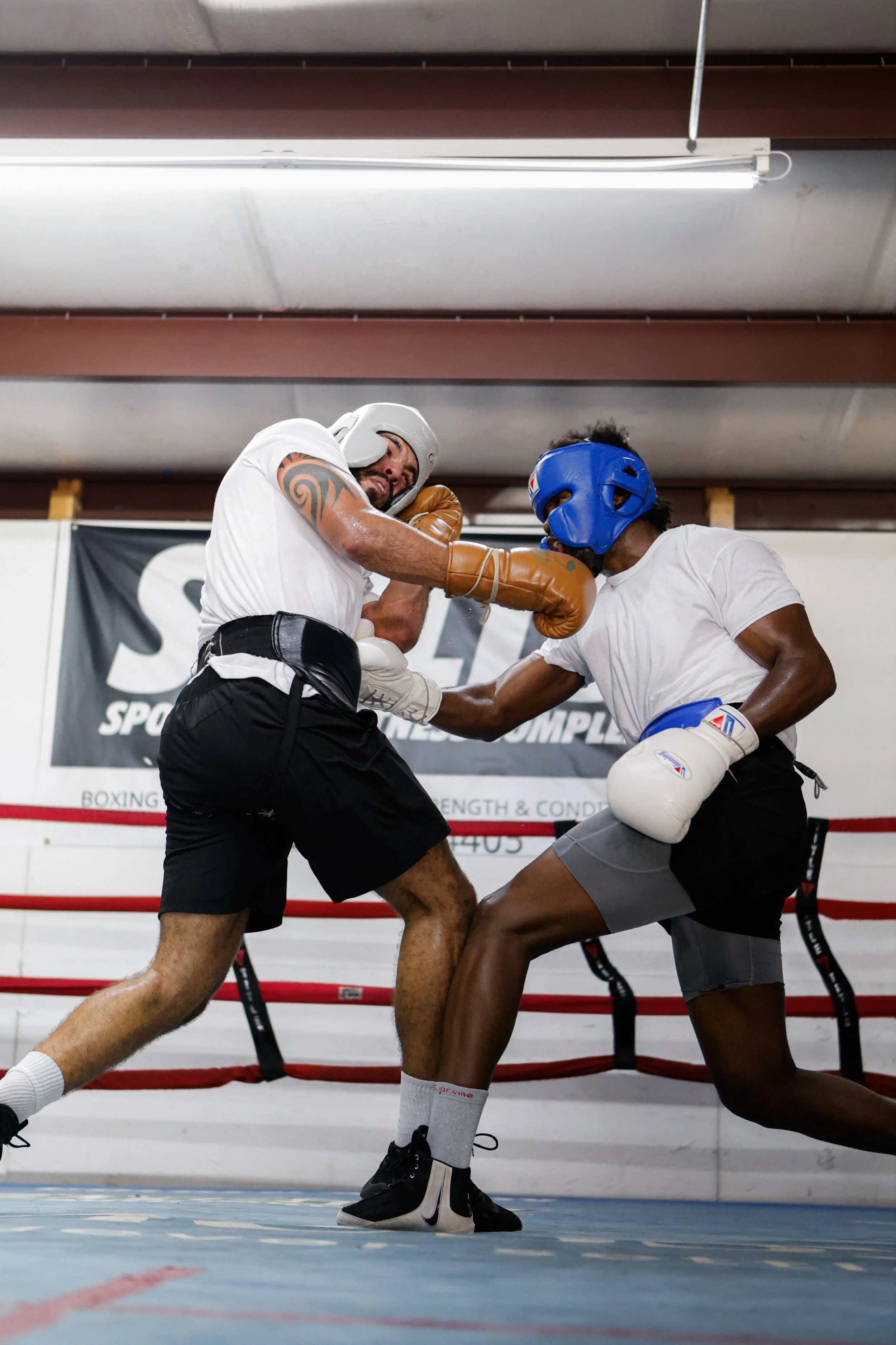 Samuel "S3" Arnold III sparring with a training partner in the ring during fight camp, throwing a punch as his partner blocks.