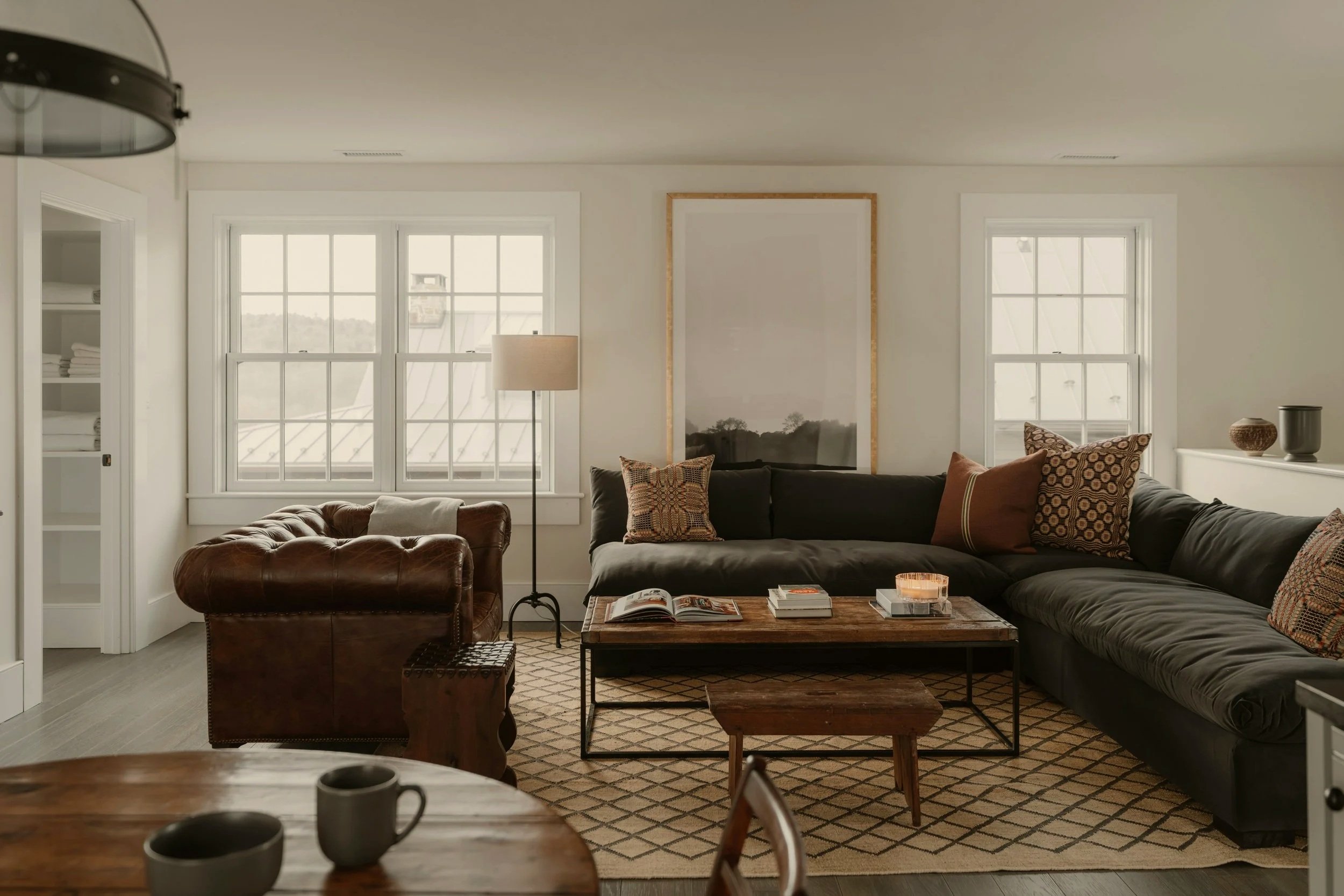 Tidy living room with leather sofa and cozy, detailed styling