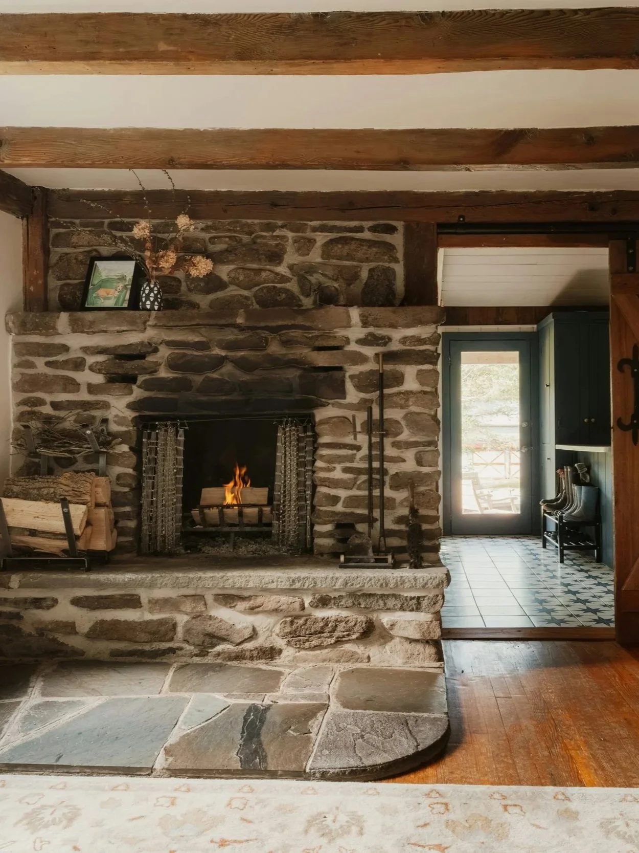 Cozy living room with a stone fireplace, cared for by Hestia Cleaning