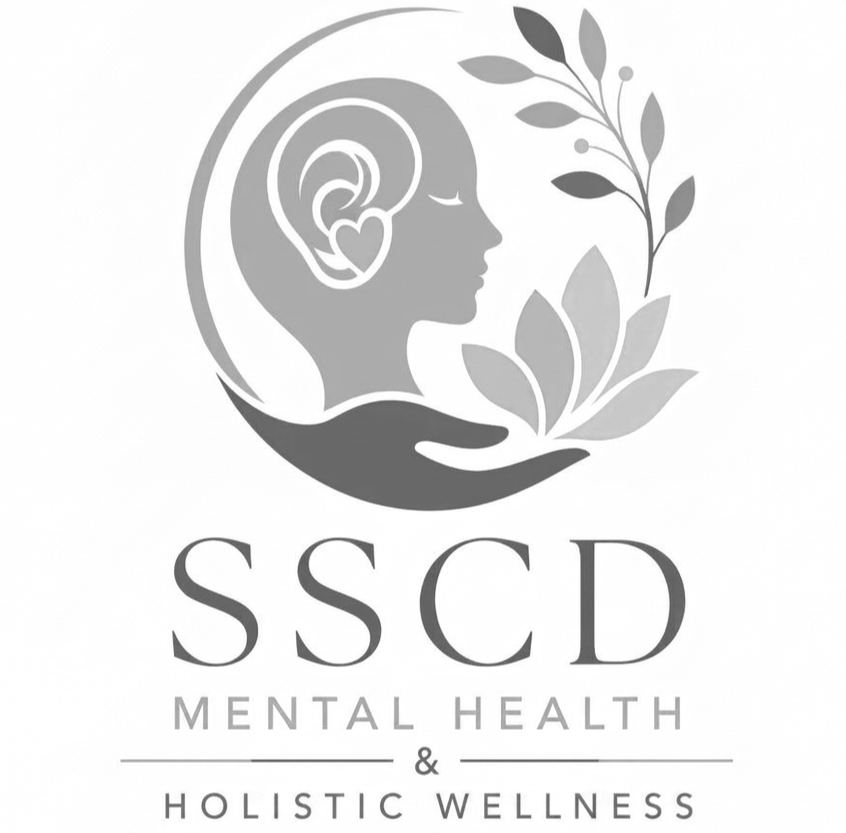 A grayscale logo featuring a woman's profile with a heart-shaped ear, surrounded by leaves and branches, with the text 'SSCD Mental Health & Holistic Wellness' below.