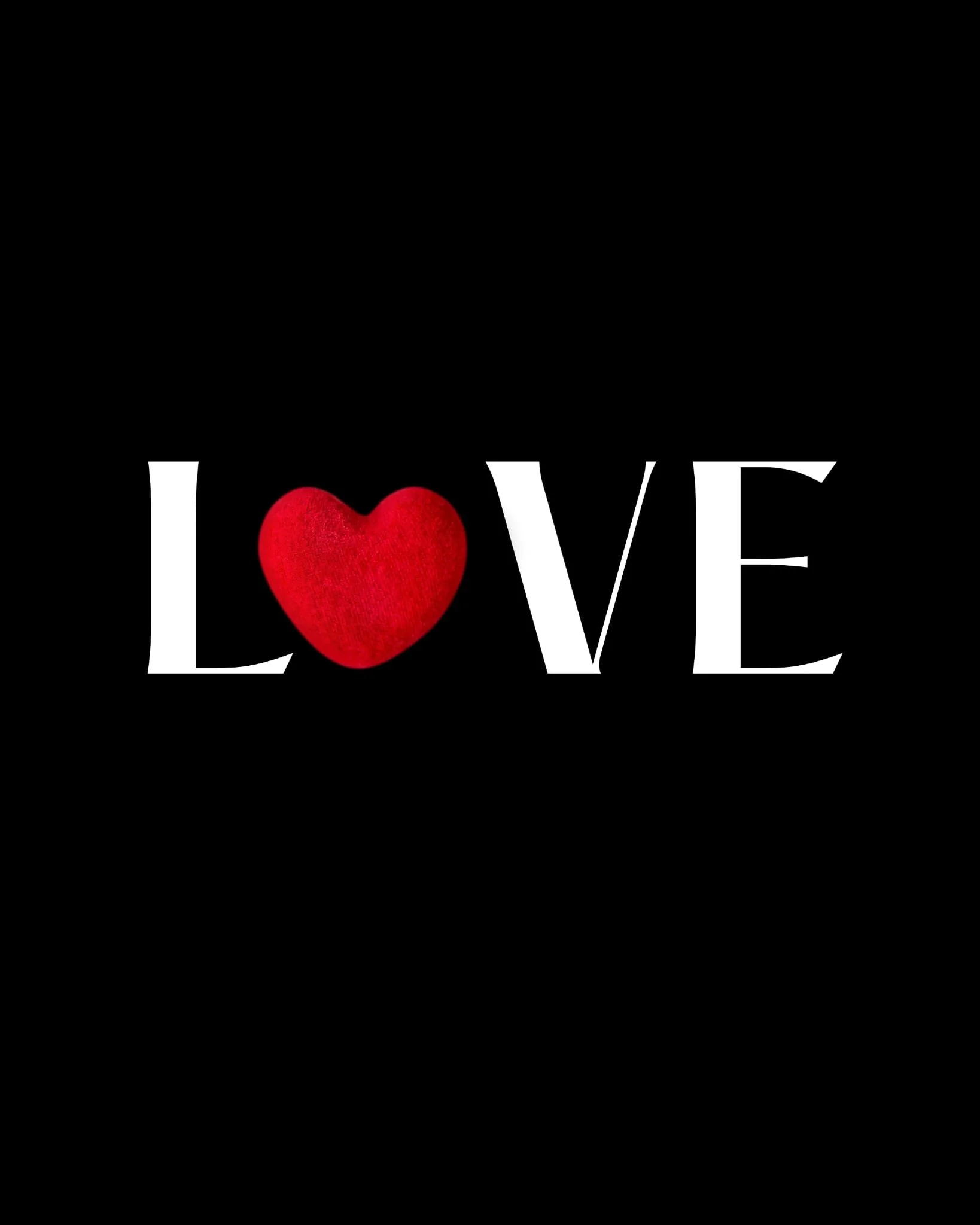 The word LOVE spelled out in large white letters on a black background with a red heart shape replacing the letter O.