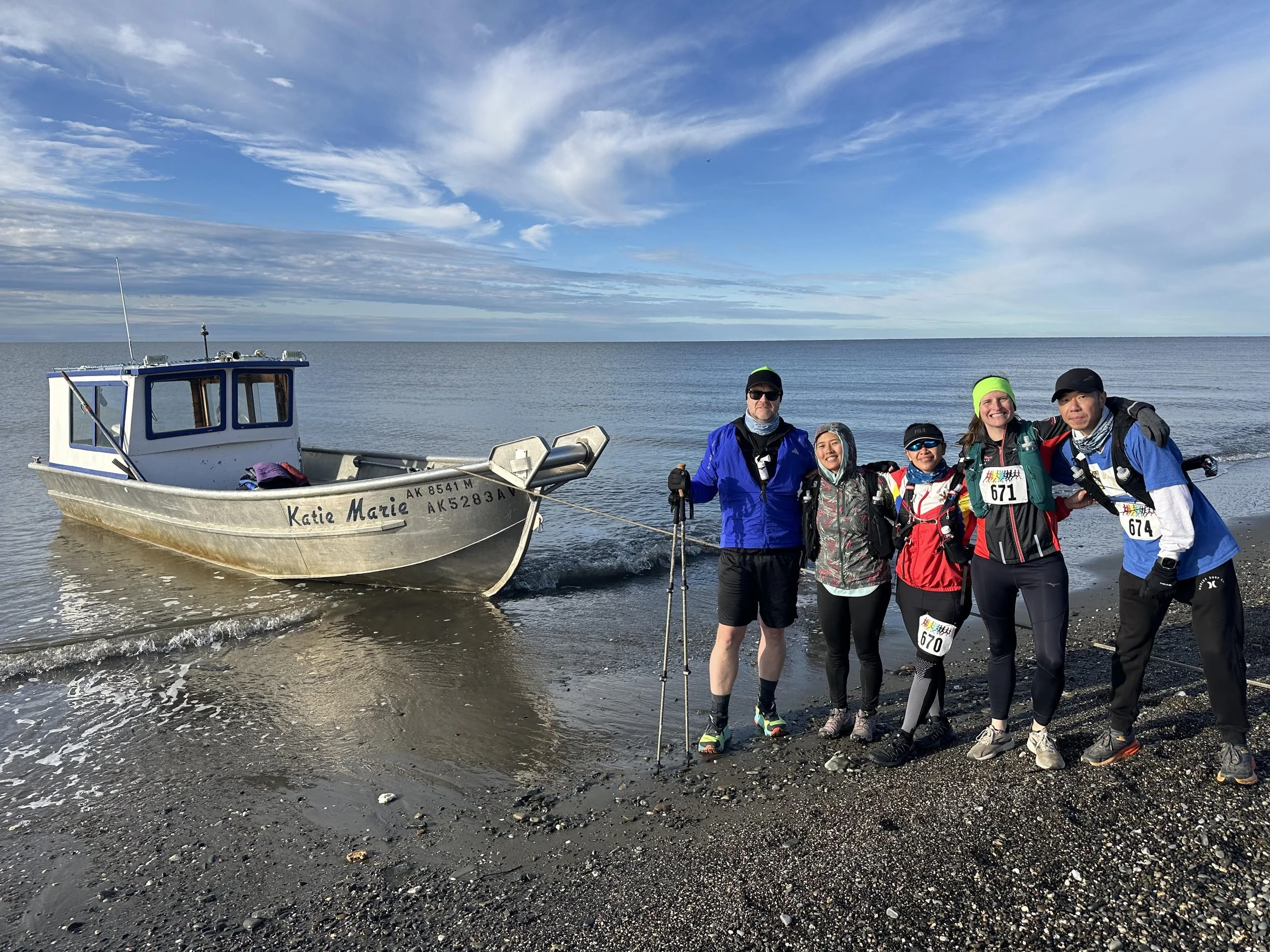 A group of hikers dropped off on the shore with the Katie Marie (Captain Ed's boat) in the background.