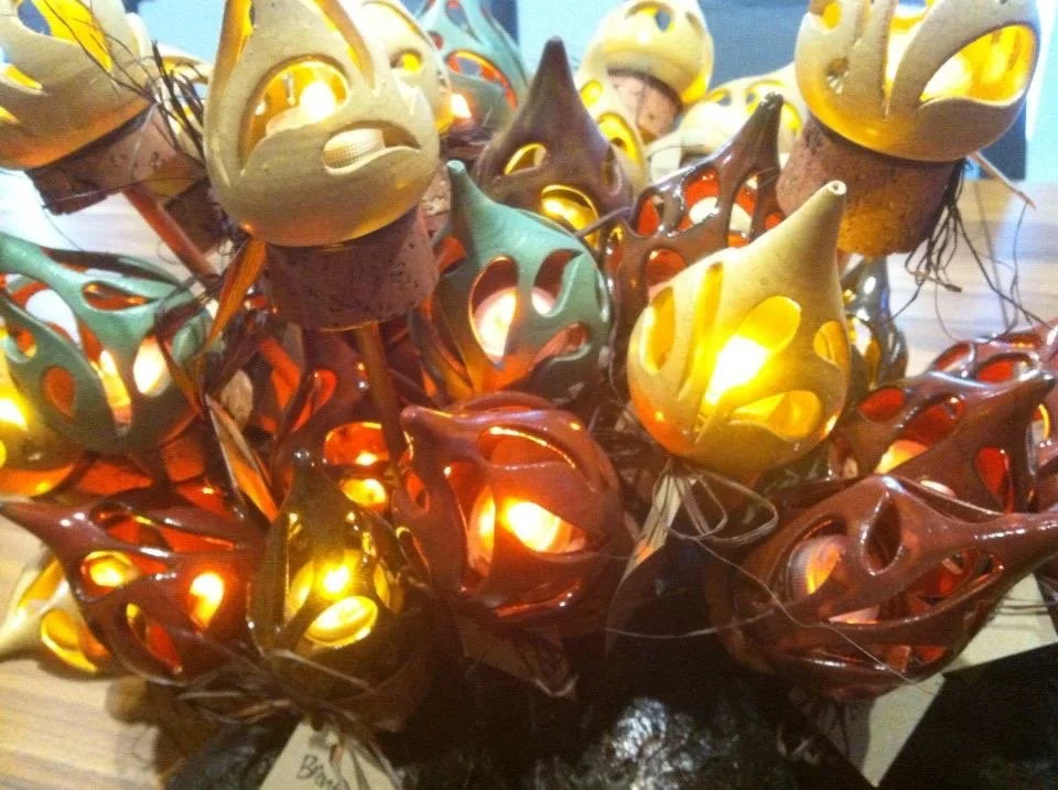 Decorative lanterns with intricate cutout designs, glowing with warm light.