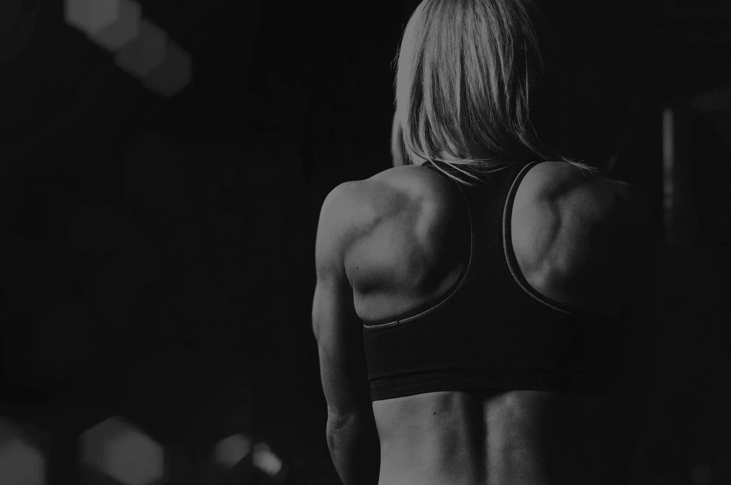 Woman building strength through personalized fitness coaching at Redefined with Alyssa.