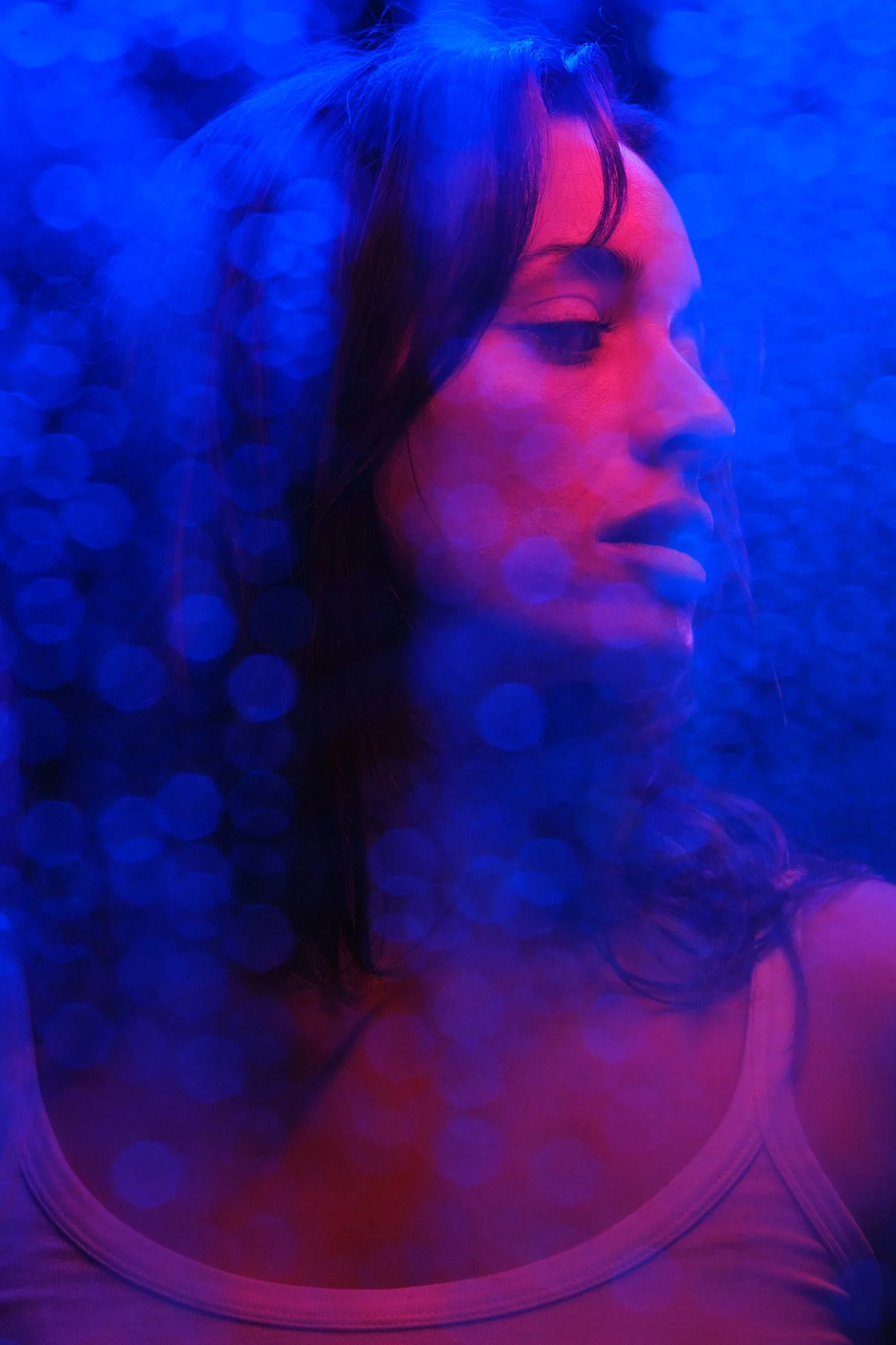Editorial portrait featuring cinematic blue and magenta lighting for a personal branding session.
