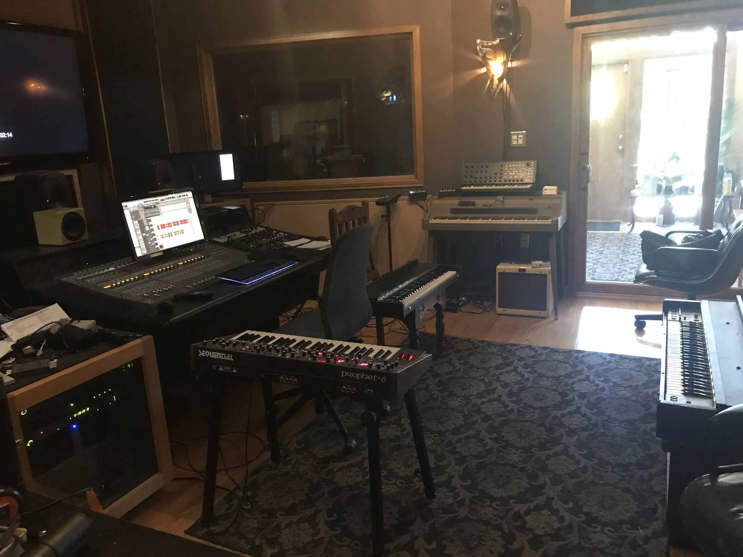 Studio with keyboards facing entry room and VO booth.