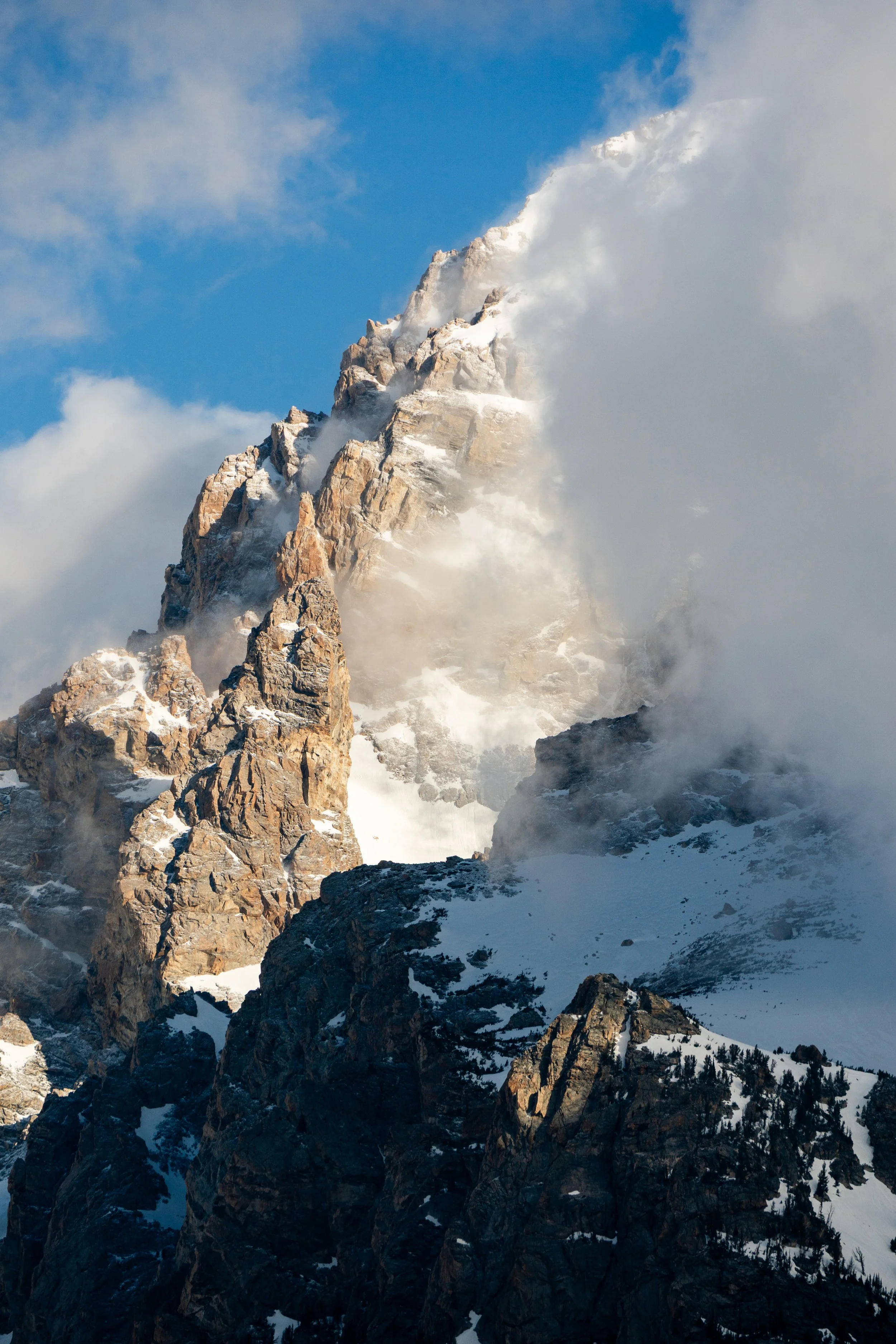 Clouds dramatically pass in front of the peak of Grand Teton. Grand Teton National Park, Wyoming.