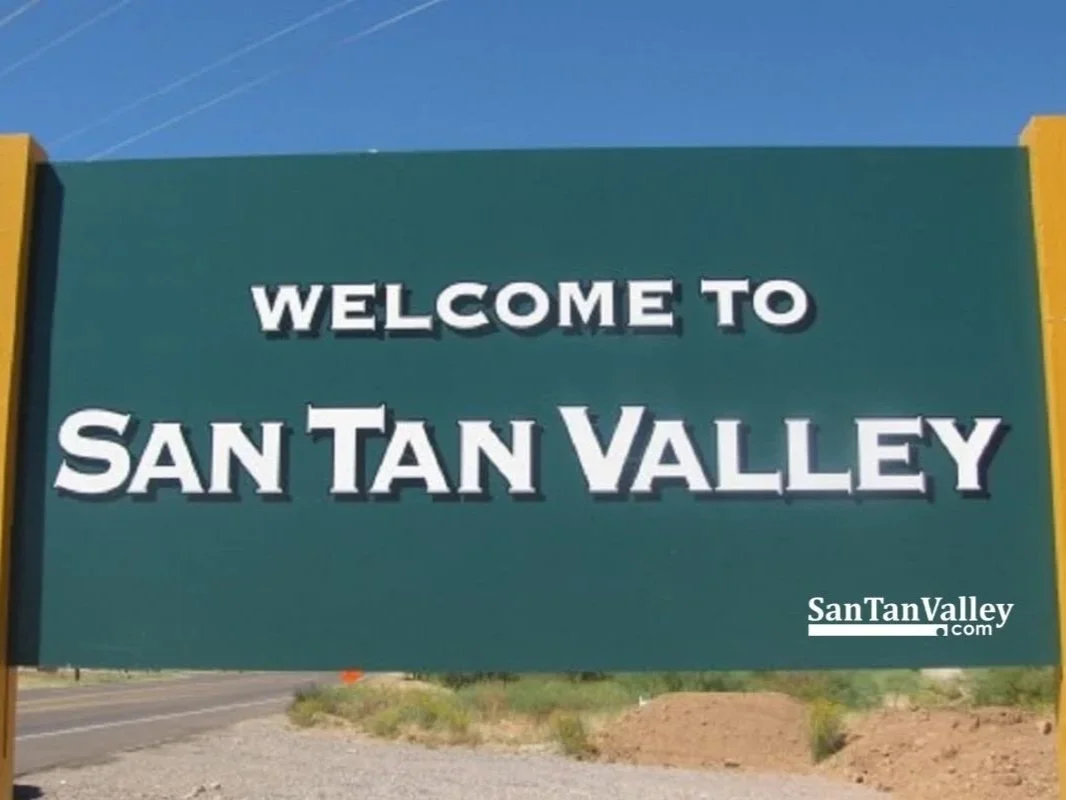 Welcome sign reading 'Welcome to San Tan Valley' with a website URL 'SanTanValley.com' at the bottom right, set against a clear blue sky.