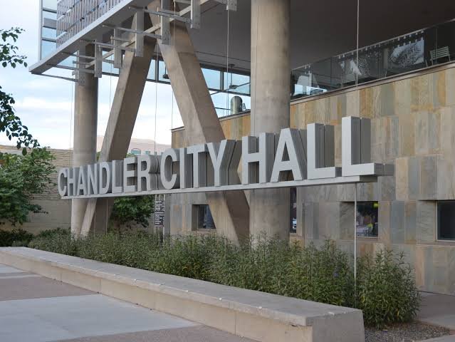 Exterior view of Chandler City Hall with large silver letters spelling out 'CHANDLER CITY HALL' mounted on the building's wall.