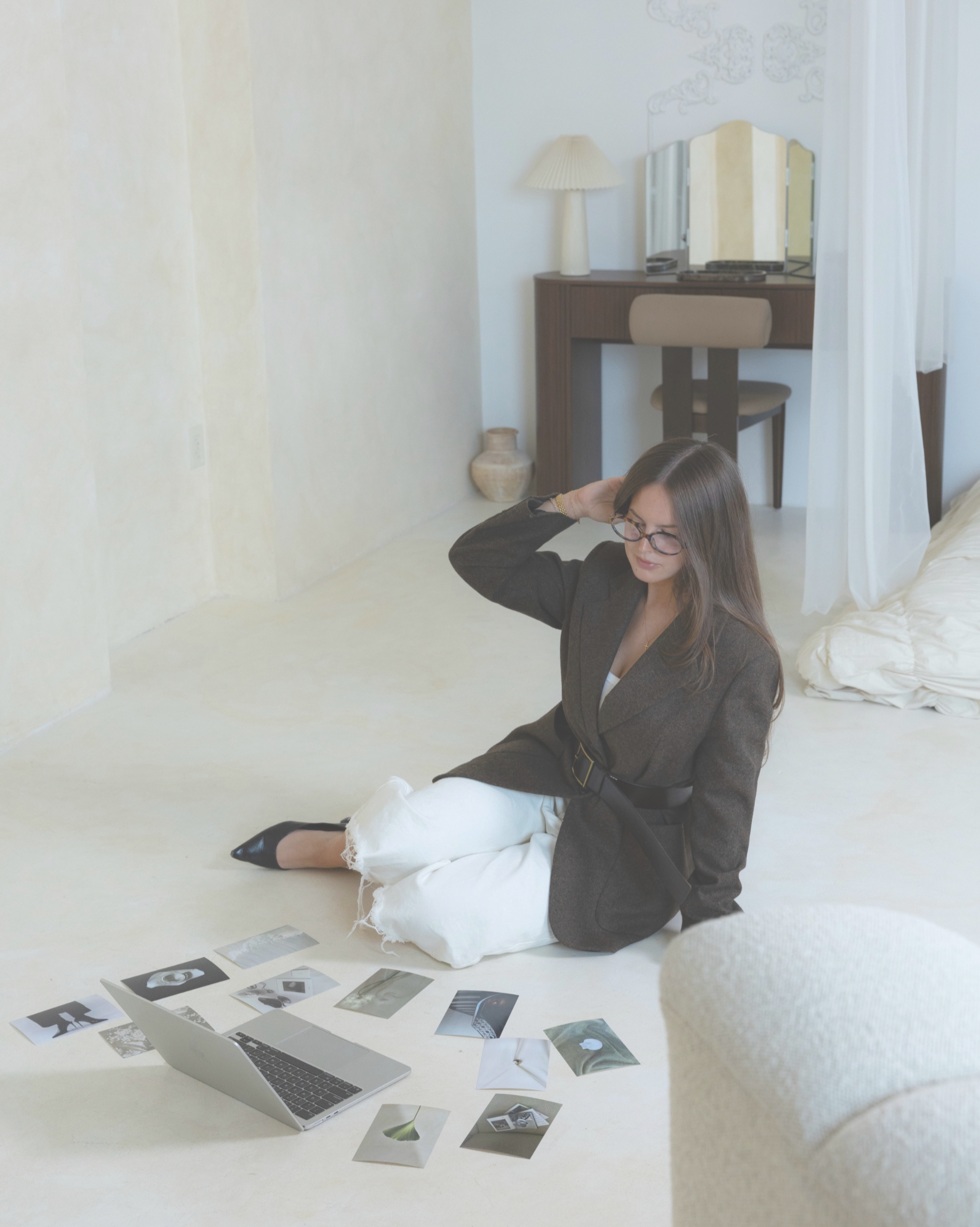 Isabela Amorim, founder of Emerald Collective, reviewing creative content and photography on her laptop.