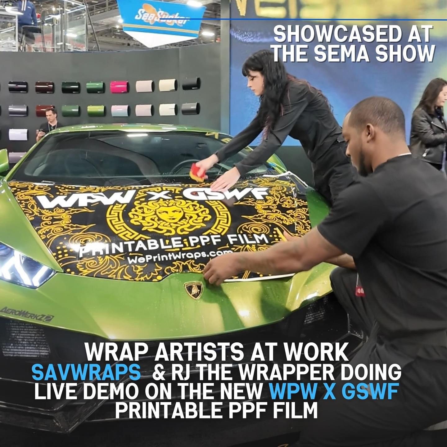 Artists applying a large, detailed, printed wrap decal onto a bright green sports car at a trade show. The wrap features black and gold ornate designs with the WPW logo and website URL.