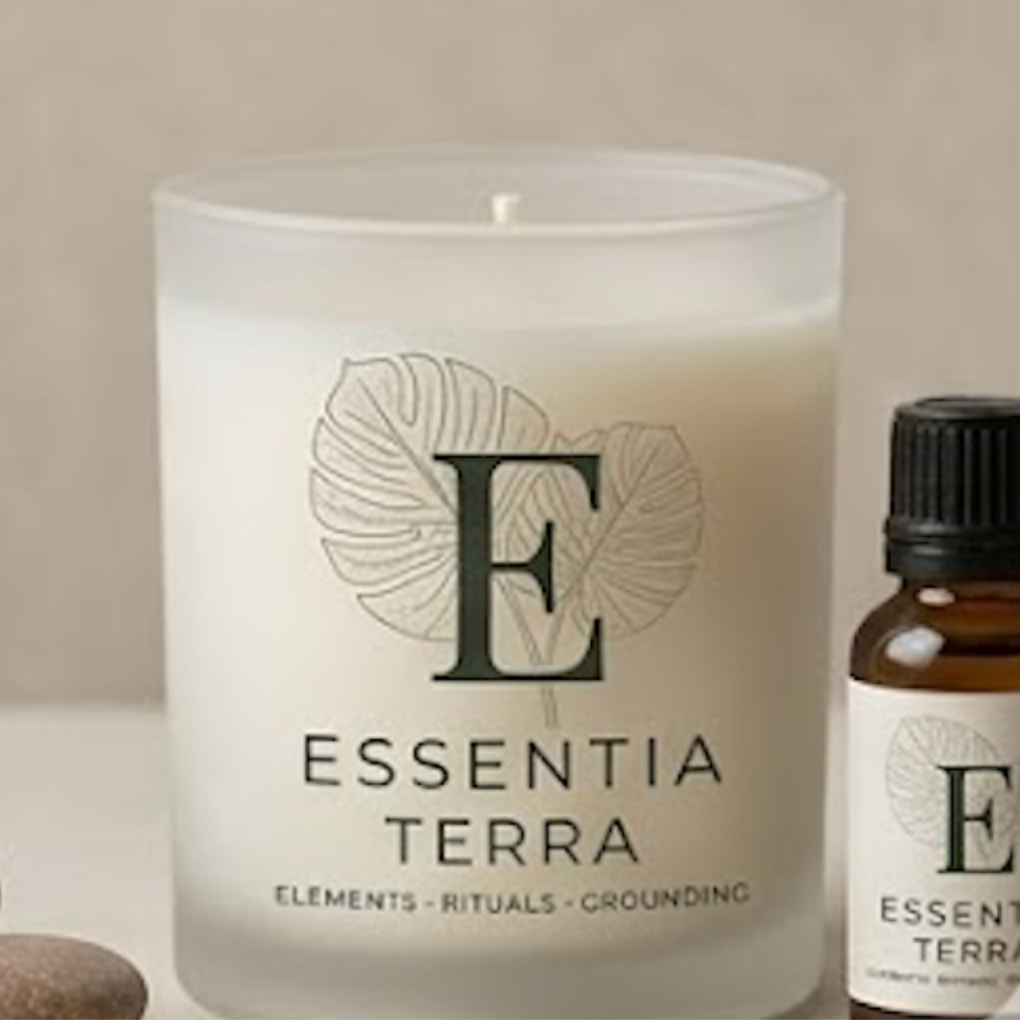A white label with black text reading 'ELEMENTS - RITUALS - GROUNDING' under a decorative leaf design, part of a product package.
