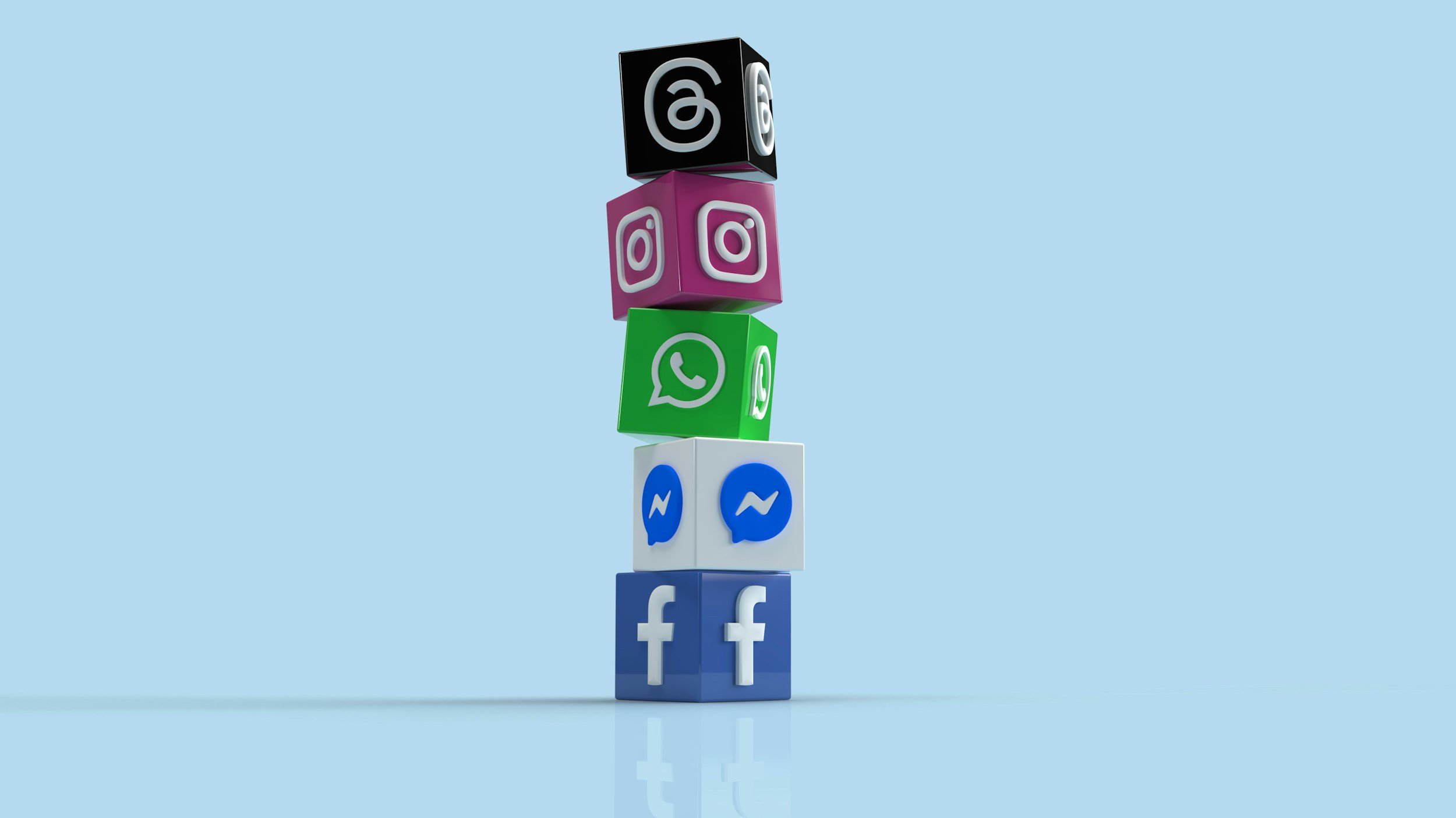 Stacked blocks with social media logos, including Facebook, Messenger, WhatsApp, Instagram, and Black Square with an Instagram logo on top, against a light blue background.