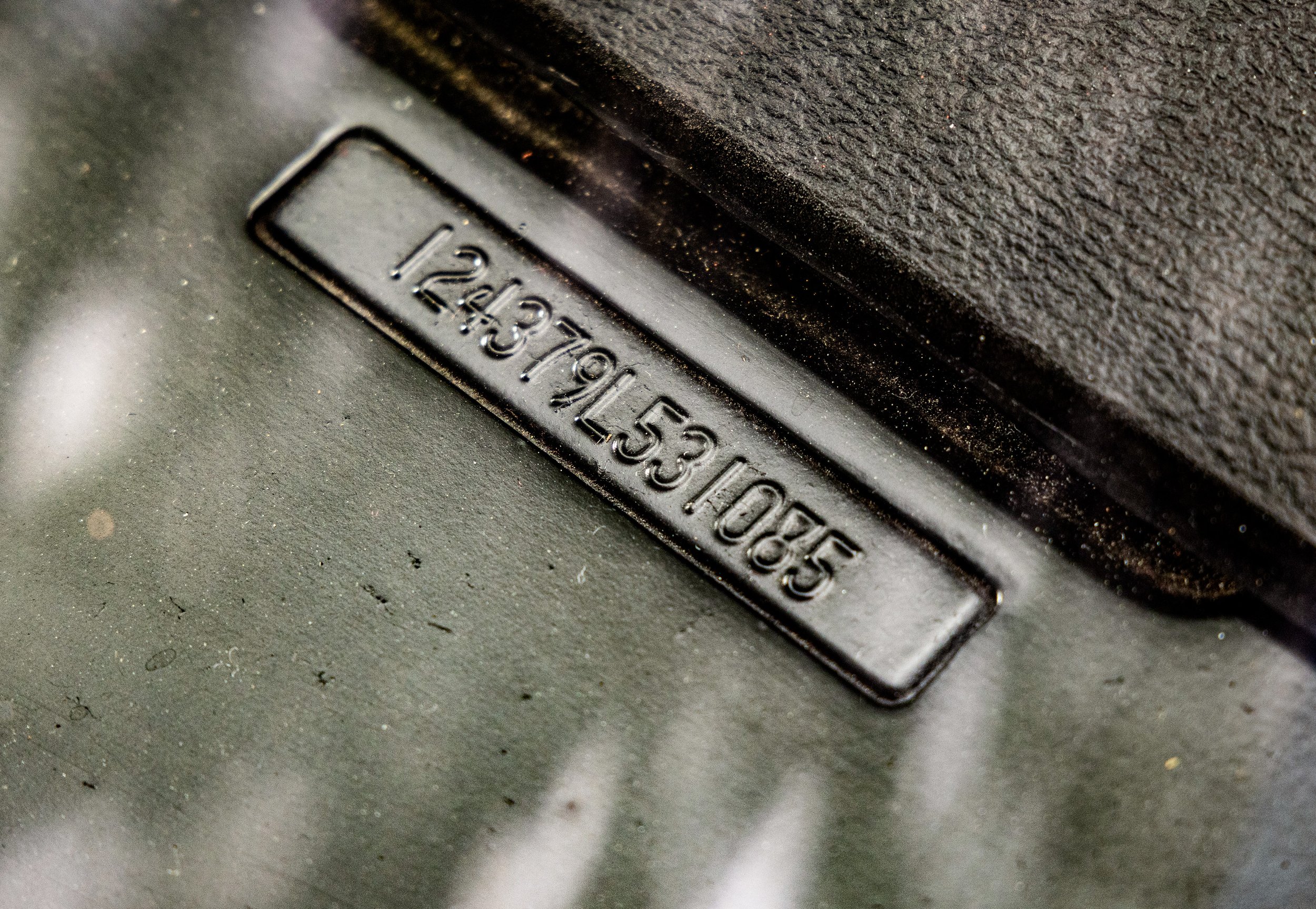 Close-up of a factory engraved on a black metal surface.