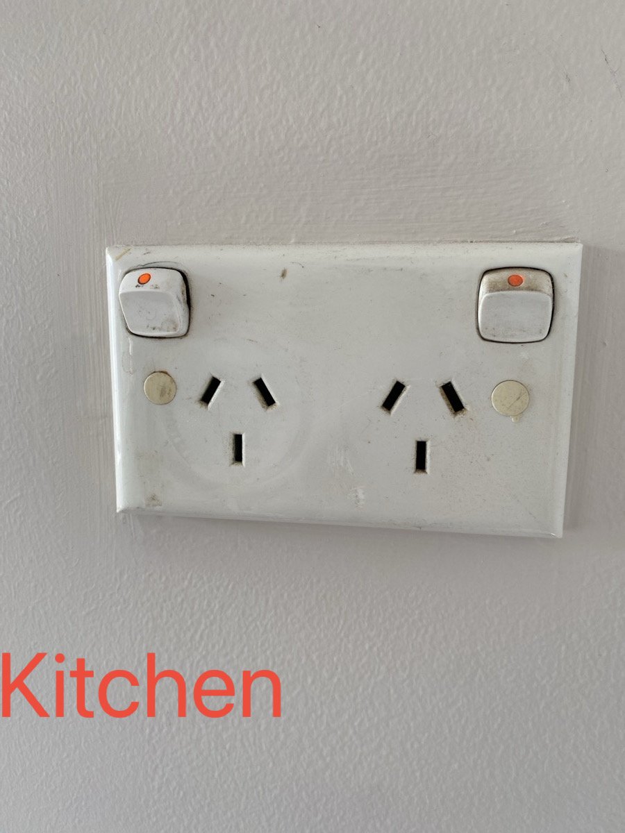 Electrical power outlet with two switches, labeled 'Kitchen' in red text.