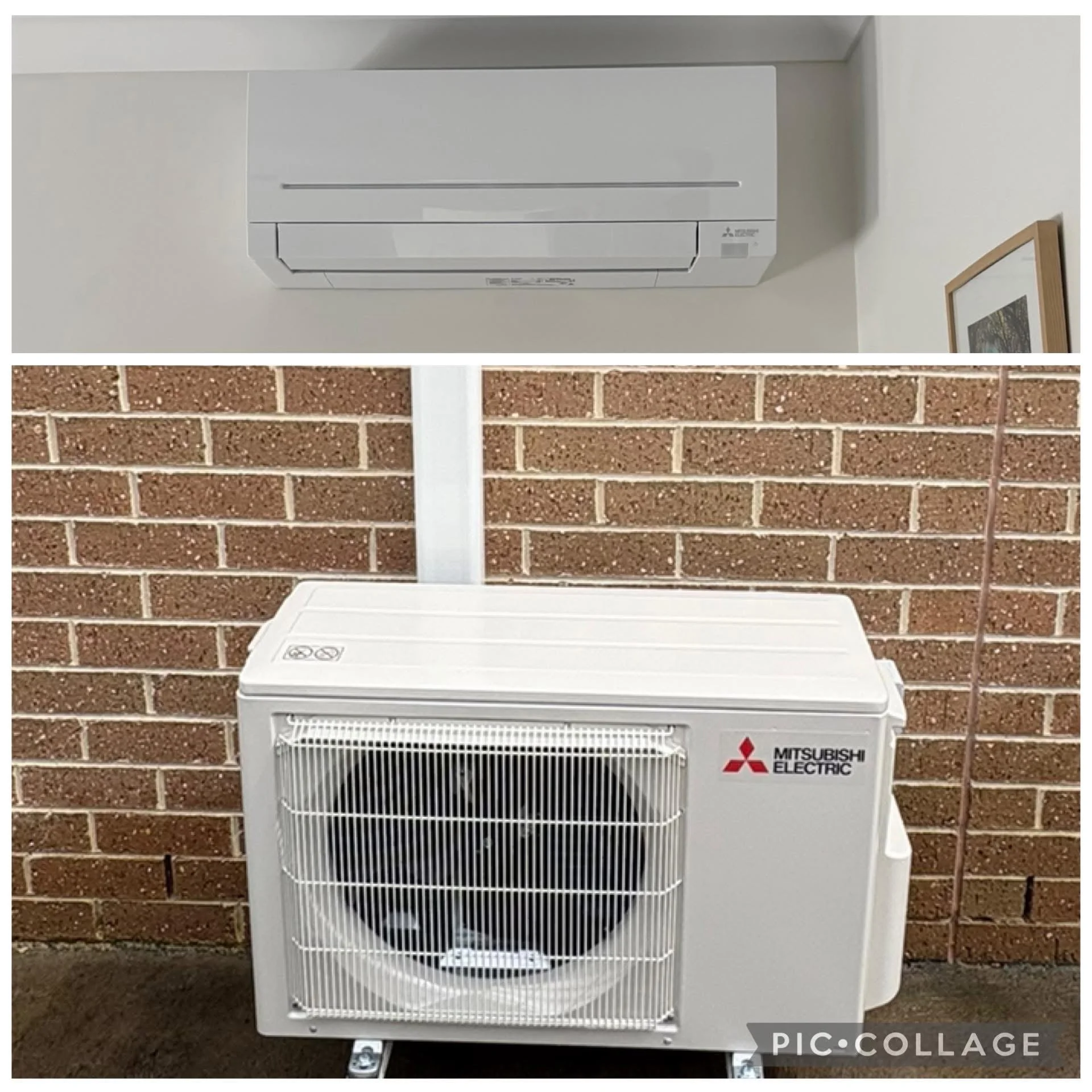 White Mitsubishi Electric portable air conditioner unit with a black vent at the bottom, placed outdoors against a brick wall.