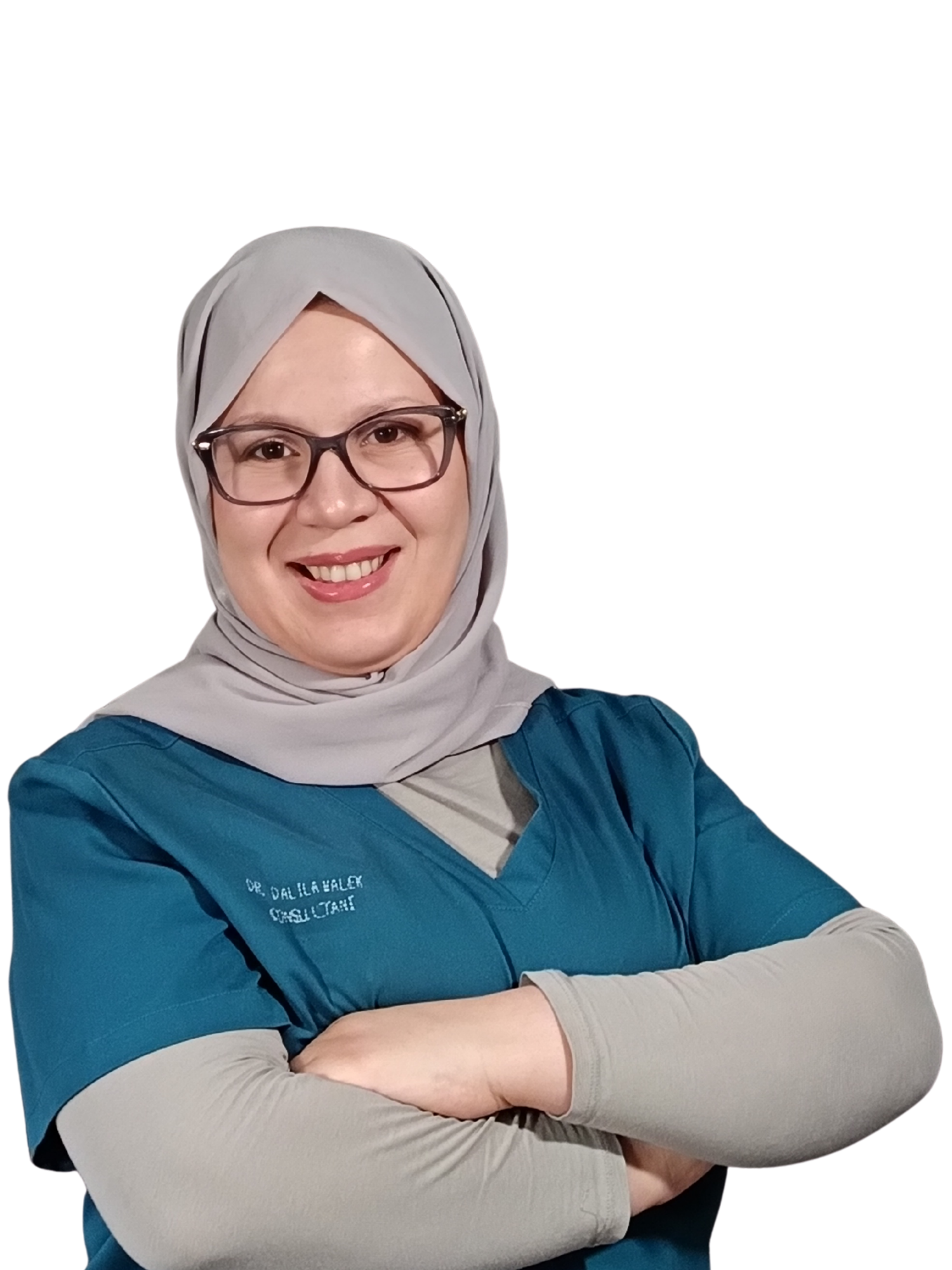 A smiling female healthcare professional wearing glasses, a gray headscarf, and a teal scrub top with her arms crossed.