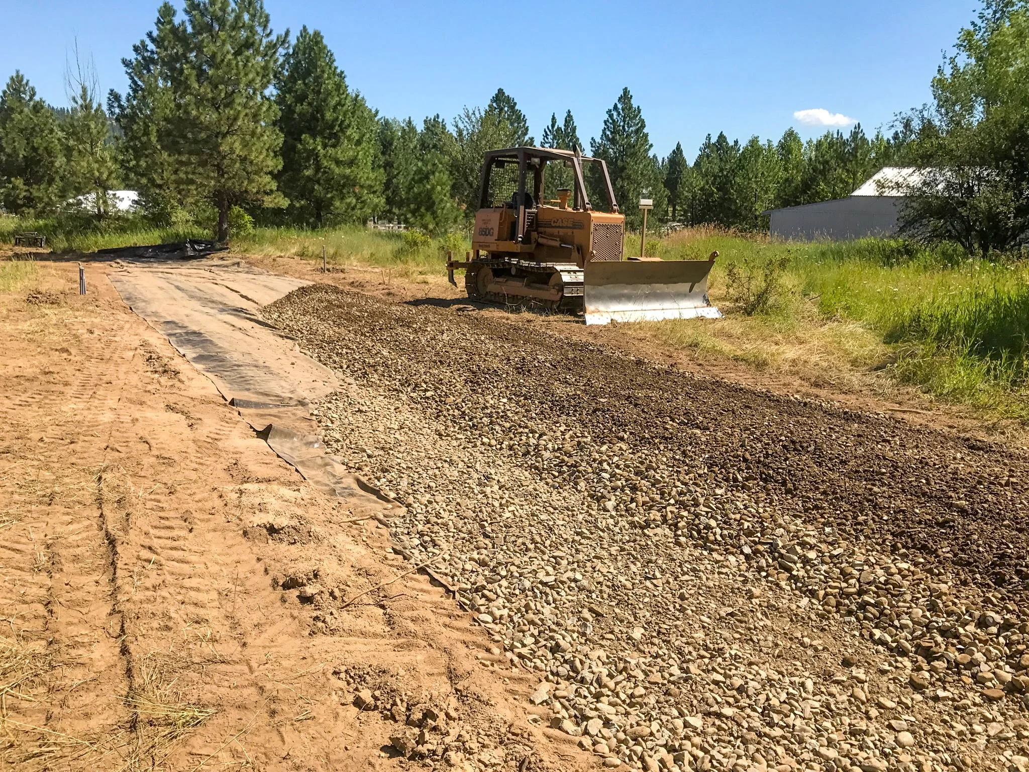 Excavating and building the roadbed for a 140' driveway on a bare land building site in Coeur D'Alene, ID.