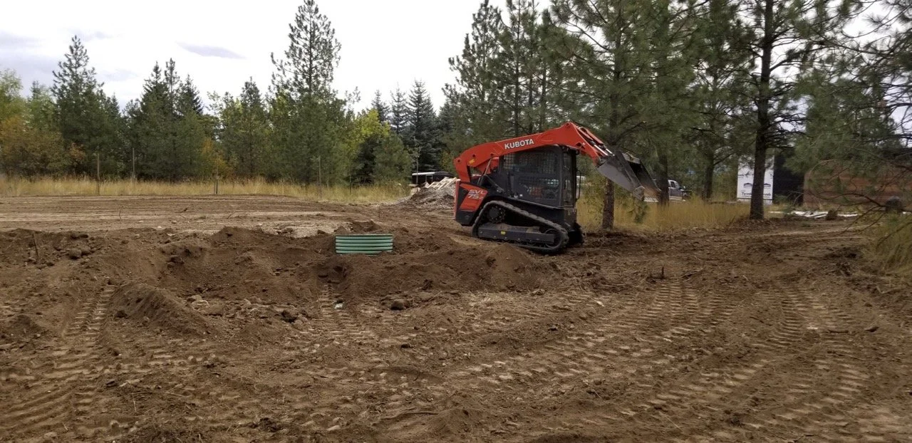 Excavating and grading the land for a building project in North Idaho.