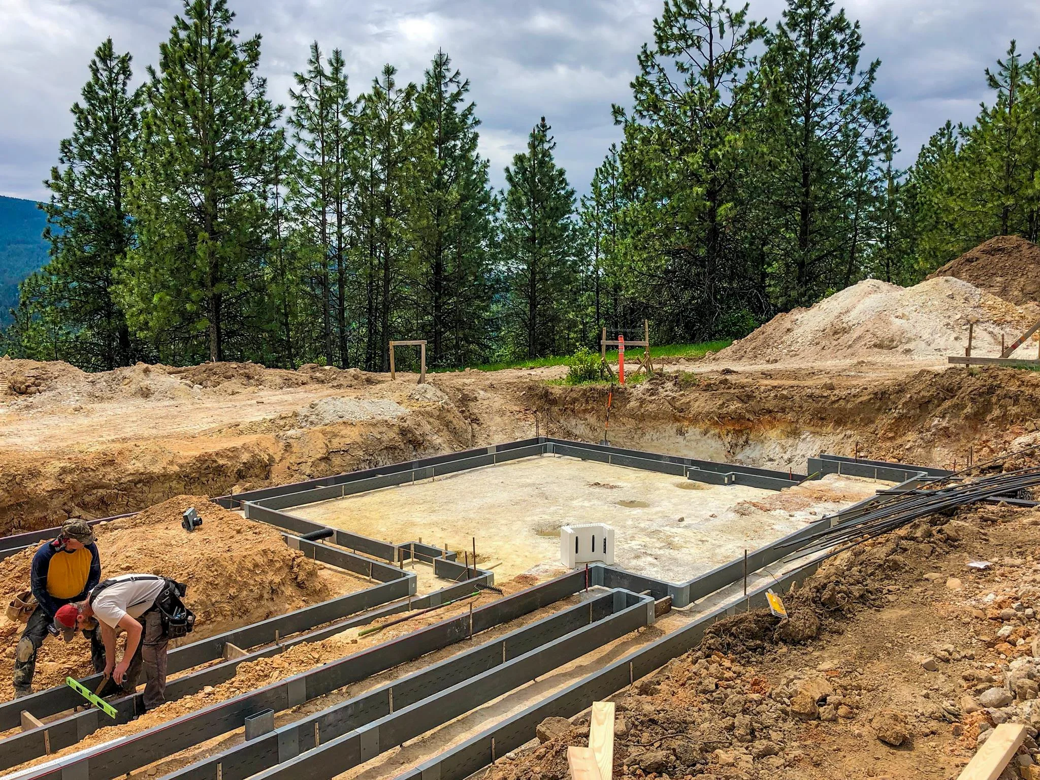 After excavation, Form-A-Drain polymer forms being assembled for the footings of a foundation for a custom home in Coeur D'Alene.